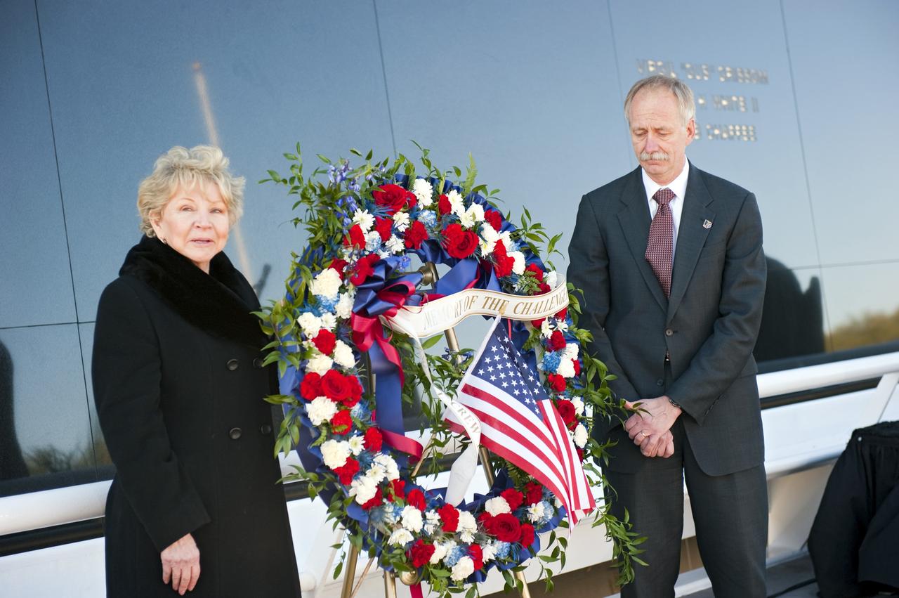 CAPE CANAVERAL, Fla. -- Dr. June Scobee Rodgers, the founding chair of the Challenger Center for Space Science Education and widow of space shuttle Challenger's STS-51L Commander Dick Scobee, left, and NASA Associate Administrator for Space Operations William Gerstenmaier pay their respects to the space shuttle Challenger crew members who gave their lives for while furthering the cause of exploration and discovery at the foot of the Space Mirror Memorial at the Kennedy Space Center Visitor Complex in Florida. 2011 marks the 25th anniversary of the loss of Challenger, which broke apart over the Atlantic Ocean 73 seconds into flight on Jan. 28, 1986.         Photo credit: NASA/Kim Shiflett