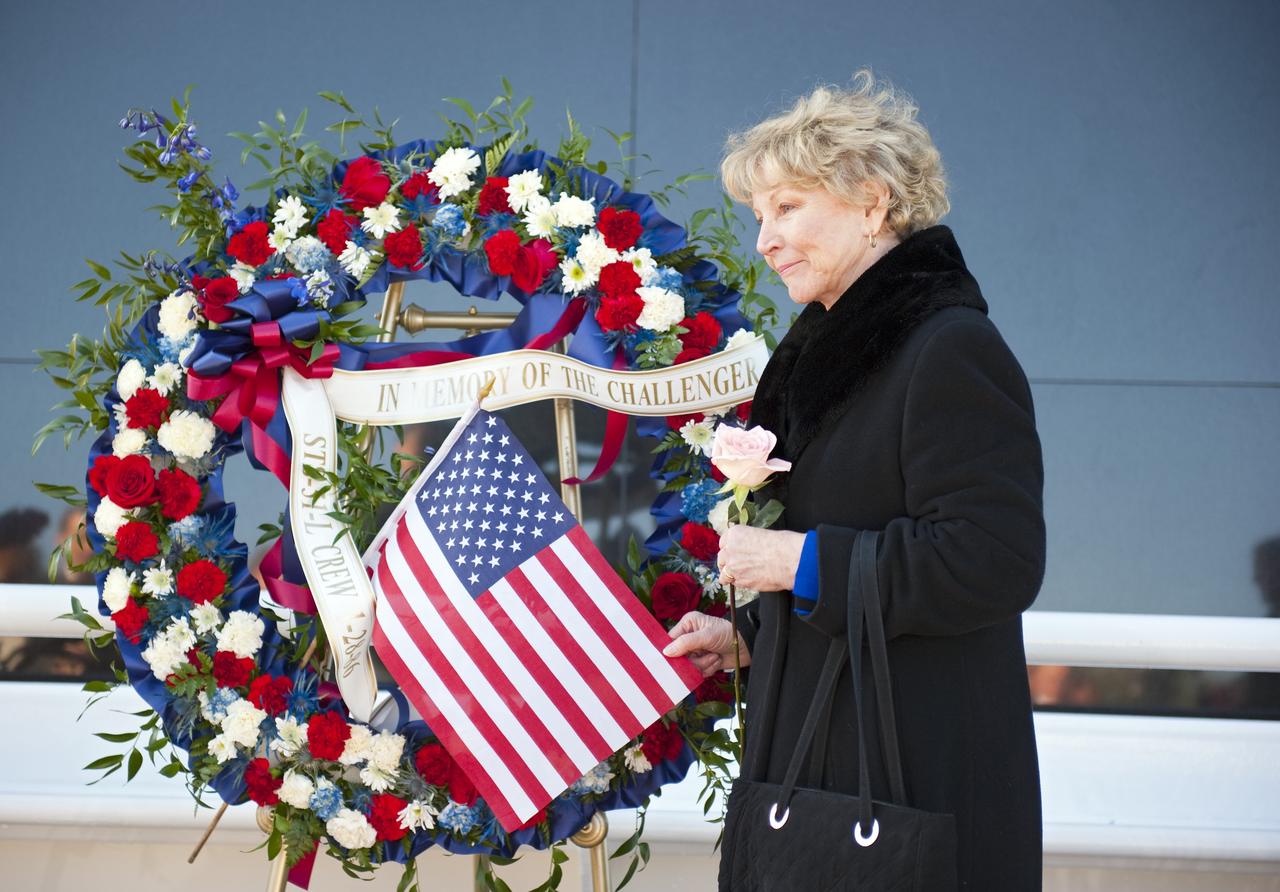 CAPE CANAVERAL, Fla. -- Dr. June Scobee Rodgers, the founding chair of the Challenger Center for Space Science Education, honors her late-husband, space shuttle Challenger's STS-51L Commander Dick Scobee, who gave his life while furthering the cause of exploration and discovery. She and others gathered at the foot of the Space Mirror Memorial at the Kennedy Space Center Visitor Complex in Florida to honor Scobee and his crewmates. 2011 marks the 25th anniversary of the loss of Challenger, which broke apart over the Atlantic Ocean 73 seconds into flight on Jan. 28, 1986.       Photo credit: NASA/Kim Shiflett