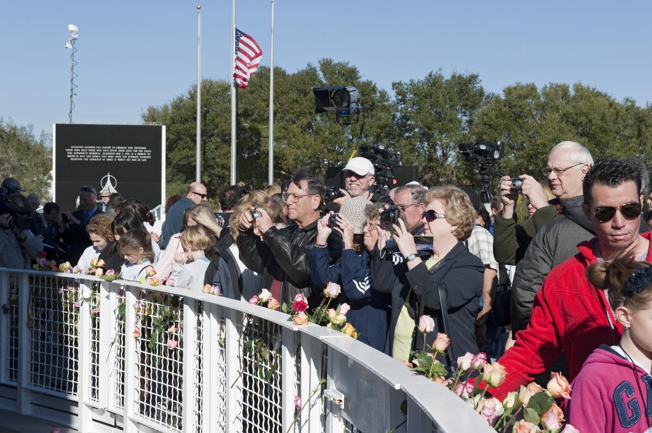 CAPE CANAVERAL, Fla. -- A crowd lays roses and pays their respects space shuttle Challenger's STS-51L crew members who gave their lives for while furthering the cause of exploration and discovery. They gathered for a memorial ceremony in front of the Space Mirror Memorial at the Kennedy Space Center Visitor Complex in Florida. 2011 marks the 25th anniversary of the loss of Challenger, which broke apart over the Atlantic Ocean 73 seconds into flight on Jan. 28, 1986.       Photo credit: NASA/Kim Shiflett
