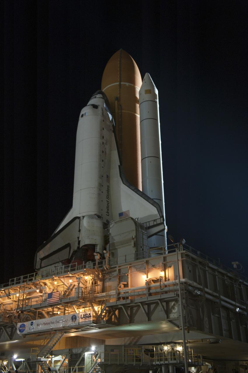 CAPE CANAVERAL, Fla. -- Xenon lights illuminate space shuttle Discovery as it makes its nighttime trek, known as "rollout," from the Vehicle Assembly Building to Launch Pad 39A at NASA's Kennedy Space Center in Florida. It will take the shuttle, attached to its external fuel tank, twin solid rocket boosters and mobile launcher platform, about seven hours to complete the move atop a crawler-transporter. This is the second time Discovery has rolled out to the pad for the STS-133 mission, and comes after a thorough check and modifications to the shuttle's external tank. Targeted to liftoff Feb. 24, Discovery will take the Permanent Multipurpose Module (PMM) packed with supplies and critical spare parts, as well as Robonaut 2 (R2) to the International Space Station. For more information on STS-133, visit www.nasa.gov/mission_pages/shuttle/shuttlemissions/sts133/. Photo credit: NASA/Kim Shiflett