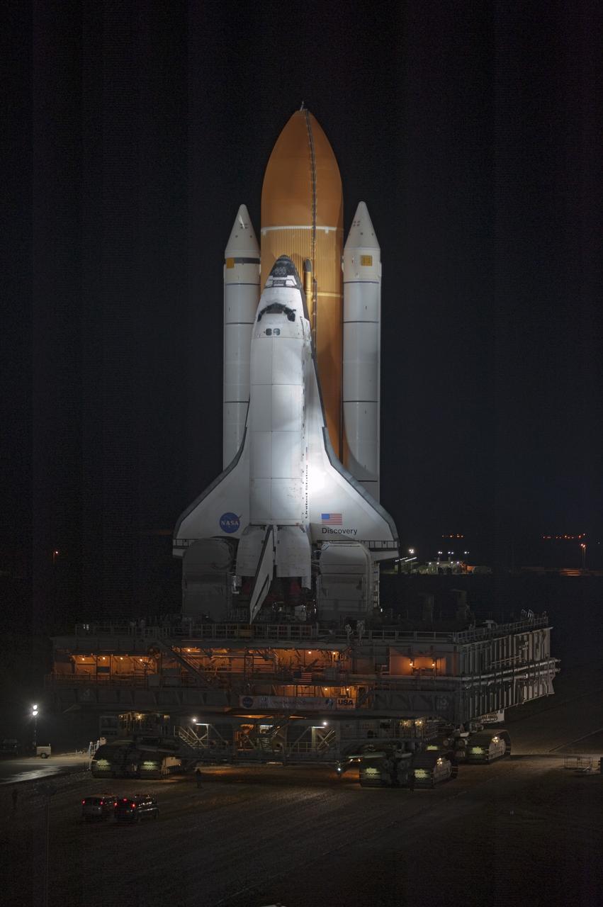 CAPE CANAVERAL, Fla. -- Xenon lights illuminate space shuttle Discovery as it makes its nighttime trek, known as "rollout," from the Vehicle Assembly Building to Launch Pad 39A at NASA's Kennedy Space Center in Florida. It will take the shuttle, attached to its external fuel tank, twin solid rocket boosters and mobile launcher platform, about seven hours to complete the move atop a crawler-transporter. This is the second time Discovery has rolled out to the pad for the STS-133 mission, and comes after a thorough check and modifications to the shuttle's external tank. Targeted to liftoff Feb. 24, Discovery will take the Permanent Multipurpose Module (PMM) packed with supplies and critical spare parts, as well as Robonaut 2 (R2) to the International Space Station. For more information on STS-133, visit www.nasa.gov/mission_pages/shuttle/shuttlemissions/sts133/. Photo credit: NASA/Kim Shiflett