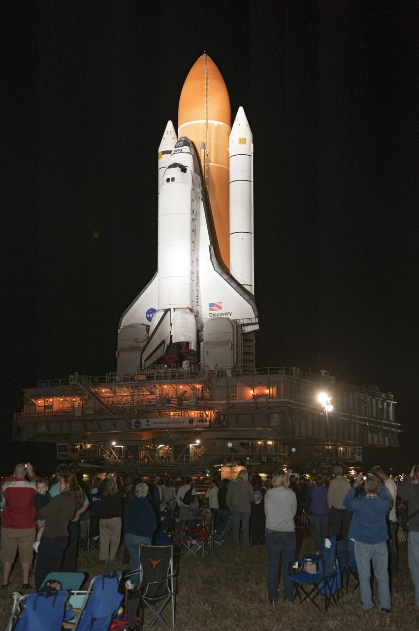 CAPE CANAVERAL, Fla. -- Outside the Vehicle Assembly Building at NASA's Kennedy Space Center in Florida, Kennedy employees, and their families and friends, are on hand to watch space shuttle Discovery roll out to Launch Pad 39A. It will take the shuttle, attached to its external fuel tank, twin solid rocket boosters and mobile launcher platform, about seven hours to complete the move atop a crawler-transporter. This is the second time Discovery has rolled out to the pad for the STS-133 mission, and comes after a thorough check and modifications to the shuttle's external tank. Targeted to liftoff Feb. 24, Discovery will take the Permanent Multipurpose Module (PMM) packed with supplies and critical spare parts, as well as Robonaut 2 (R2) to the International Space Station. For more information on STS-133, visit www.nasa.gov/mission_pages/shuttle/shuttlemissions/sts133/. Photo credit: NASA/Kim Shiflett
