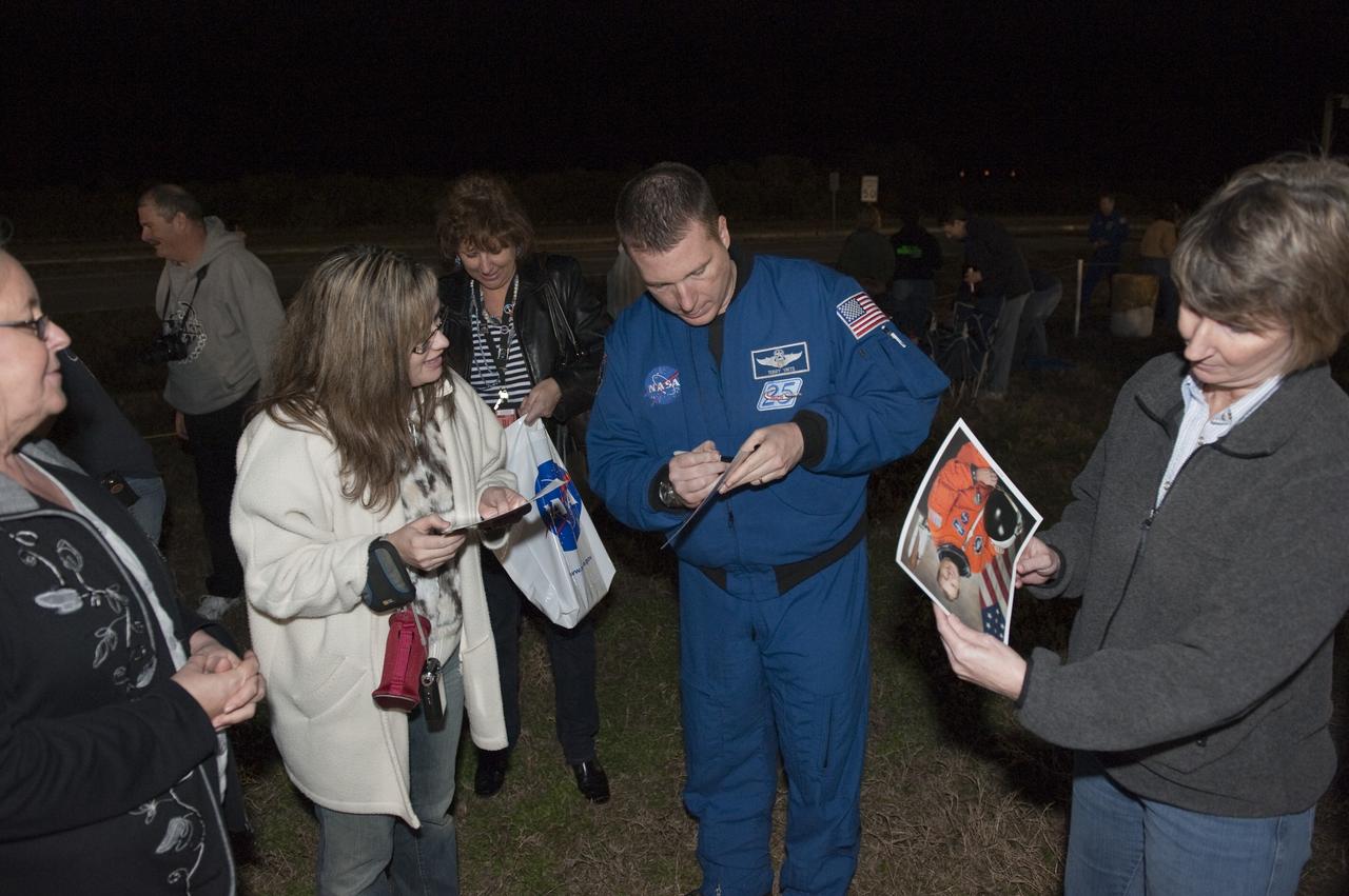 CAPE CANAVERAL, Fla. -- NASA astronaut Terry Virts signs autographs outside the Vehicle Assembly Building at NASA's Kennedy Space Center in Florida while space shuttle Discovery rolls out to Launch Pad 39A. It will take the shuttle, attached to its external fuel tank, twin solid rocket boosters and mobile launcher platform, about seven hours to complete the move atop a crawler-transporter. This is the second time Discovery has rolled out to the pad for the STS-133 mission, and comes after a thorough check and modifications to the shuttle's external tank. Virts was pilot on the STS-130 mission that took the seven-windowed cupola to the International Space Station in 2010. Targeted to liftoff Feb. 24, Discovery will take the Permanent Multipurpose Module (PMM) packed with supplies and critical spare parts, as well as Robonaut 2 (R2) to the International Space Station. For more information on STS-133, visit www.nasa.gov/mission_pages/shuttle/shuttlemissions/sts133/. Photo credit: NASA/Kim Shiflett