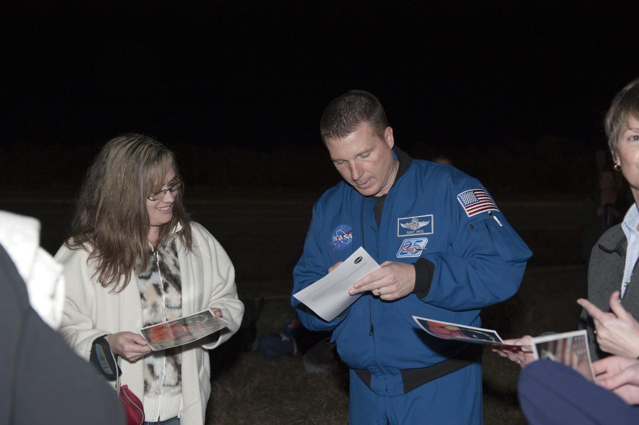 CAPE CANAVERAL, Fla. -- NASA astronaut Terry Virts signs autographs outside the Vehicle Assembly Building at NASA's Kennedy Space Center in Florida while space shuttle Discovery rolls out to Launch Pad 39A. It will take the shuttle, attached to its external fuel tank, twin solid rocket boosters and mobile launcher platform, about seven hours to complete the move atop a crawler-transporter. This is the second time Discovery has rolled out to the pad for the STS-133 mission, and comes after a thorough check and modifications to the shuttle's external tank. Virts was pilot on the STS-130 mission that took the seven-windowed cupola to the International Space Station in 2010. Targeted to liftoff Feb. 24, Discovery will take the Permanent Multipurpose Module (PMM) packed with supplies and critical spare parts, as well as Robonaut 2 (R2) to the International Space Station. For more information on STS-133, visit www.nasa.gov/mission_pages/shuttle/shuttlemissions/sts133/. Photo credit: NASA/Kim Shiflett