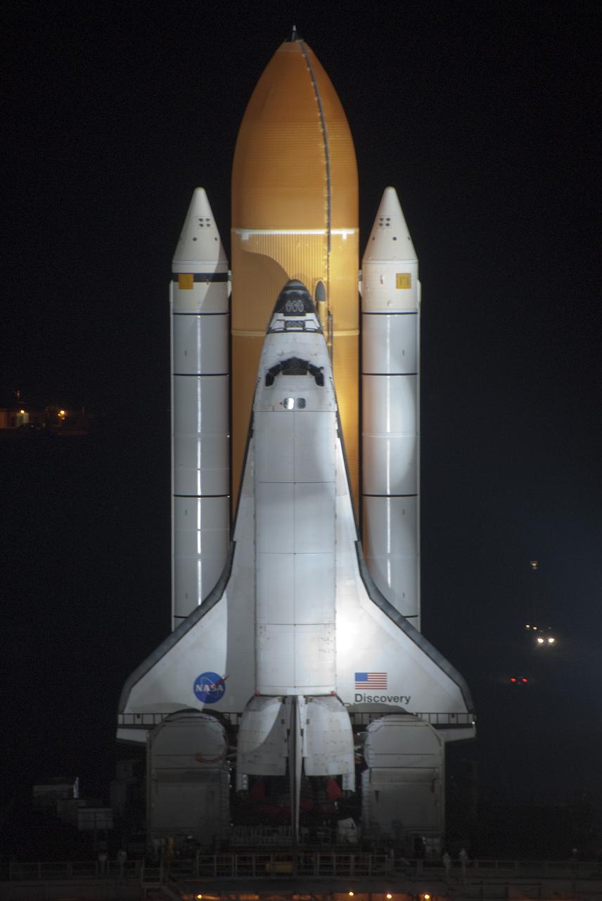 CAPE CANAVERAL, Fla. -- Xenon lights illuminate space shuttle Discovery as it makes its nighttime trek, known as "rollout," from the Vehicle Assembly Building to Launch Pad 39A at NASA's Kennedy Space Center in Florida. It will take the shuttle, attached to its external fuel tank, twin solid rocket boosters and mobile launcher platform, about seven hours to complete the move atop a crawler-transporter. This is the second time Discovery has rolled out to the pad for the STS-133 mission, and comes after a thorough check and modifications to the shuttle's external tank. Targeted to liftoff Feb. 24, Discovery will take the Permanent Multipurpose Module (PMM) packed with supplies and critical spare parts, as well as Robonaut 2 (R2) to the International Space Station. For more information on STS-133, visit www.nasa.gov/mission_pages/shuttle/shuttlemissions/sts133/. Photo credit: NASA/Jim Grossmann