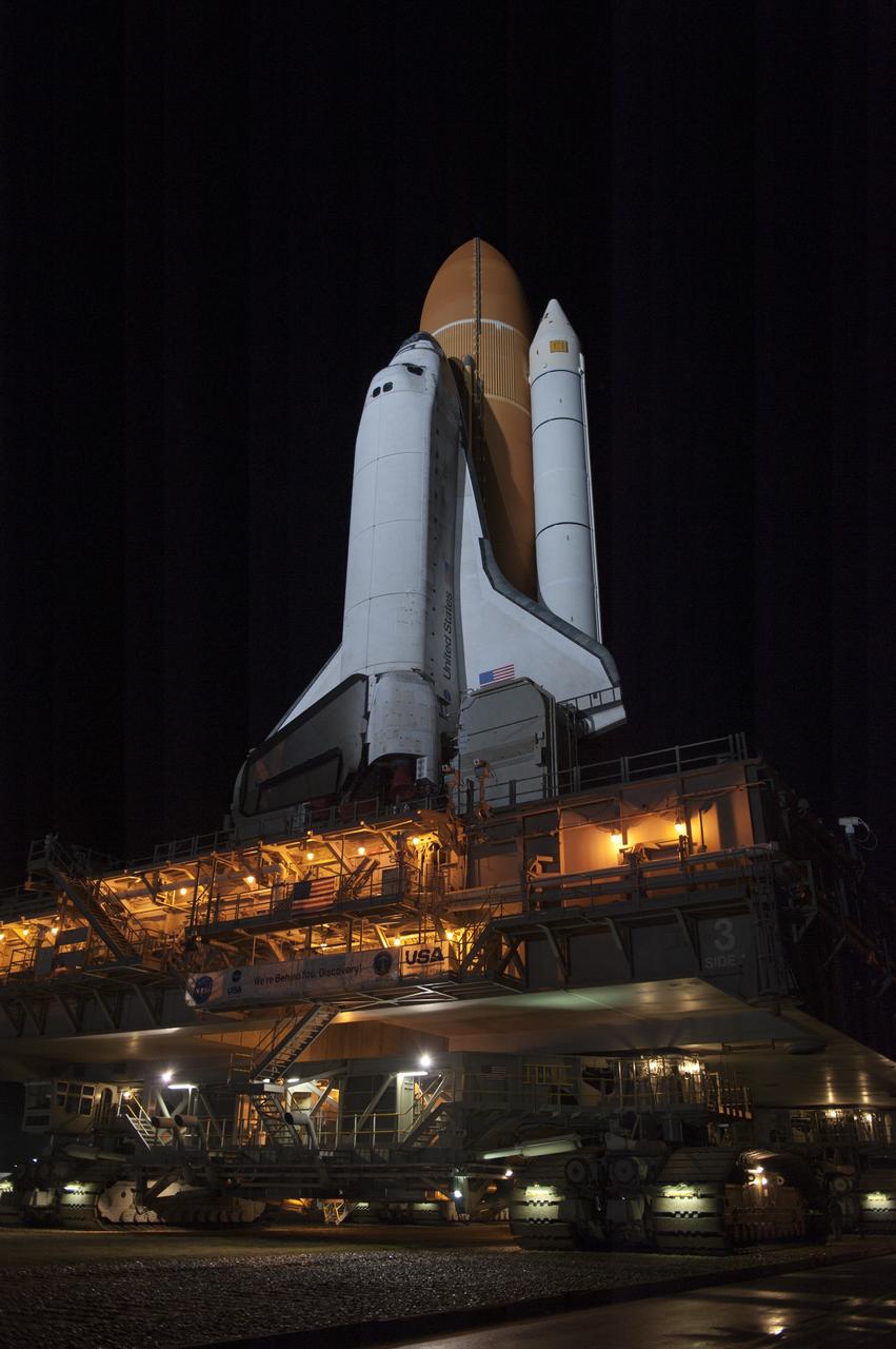 CAPE CANAVERAL, Fla. -- Xenon lights illuminate space shuttle Discovery as it makes its nighttime trek, known as "rollout," from the Vehicle Assembly Building to Launch Pad 39A at NASA's Kennedy Space Center in Florida. It will take the shuttle, attached to its external fuel tank, twin solid rocket boosters and mobile launcher platform, about seven hours to complete the move atop a crawler-transporter. This is the second time Discovery has rolled out to the pad for the STS-133 mission, and comes after a thorough check and modifications to the shuttle's external tank. Targeted to liftoff Feb. 24, Discovery will take the Permanent Multipurpose Module (PMM) packed with supplies and critical spare parts, as well as Robonaut 2 (R2) to the International Space Station. For more information on STS-133, visit www.nasa.gov/mission_pages/shuttle/shuttlemissions/sts133/. Photo credit: NASA/Kim Shiflett