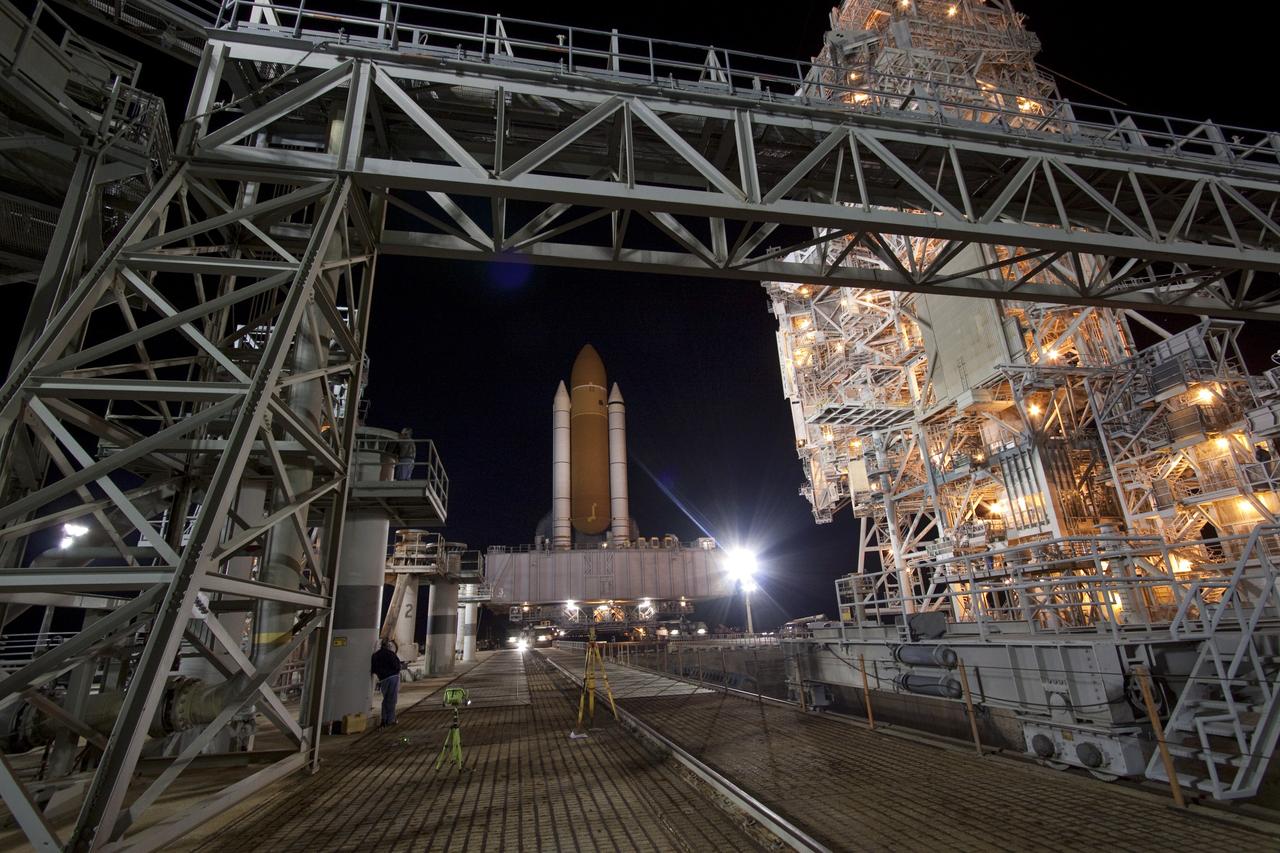 CAPE CANAVERAL, Fla. -- A worker monitors space shuttle Discovery as it arrives at Launch Pad 39A from the Vehicle Assembly Building at NASA's Kennedy Space Center in Florida. It took the shuttle, attached to its external fuel tank, twin solid rocket boosters and mobile launcher platform, about seven hours to complete the move atop a crawler-transporter. This is the second time Discovery has rolled out to the pad for the STS-133 mission, and comes after a thorough check and modifications to the shuttle's external tank. Targeted to liftoff Feb. 24, Discovery will take the Permanent Multipurpose Module (PMM) packed with supplies and critical spare parts, as well as Robonaut 2 (R2) to the International Space Station. For more information on STS-133, visit www.nasa.gov/mission_pages/shuttle/shuttlemissions/sts133/. Photo credit: NASA/Jack Pfaller