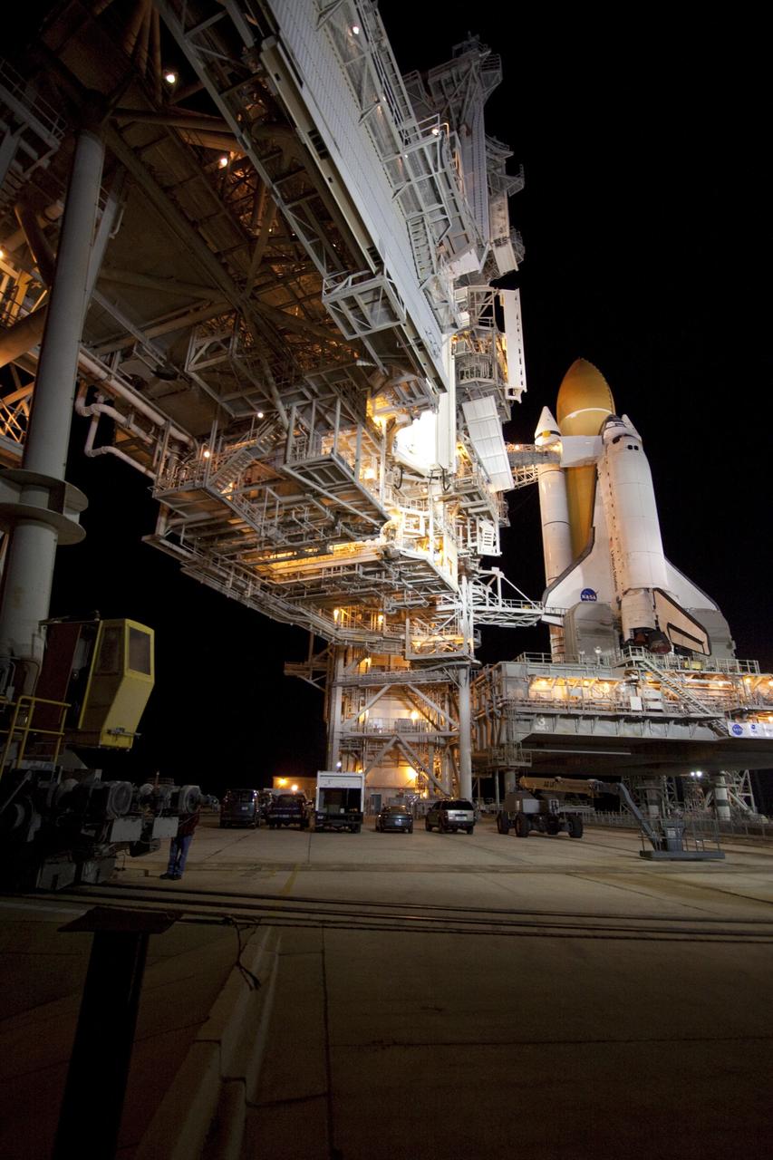CAPE CANAVERAL, Fla. -- The rotating service structure (RSS), which provides weather protection and access to the shuttle, begins to move into place around space shuttle Discovery on Launch Pad 39A at NASA's Kennedy Space Center in Florida. This comes after Discovery, attached to its external fuel tank, twin solid rocket boosters and mobile launcher platform, rolled out to the pad from the Vehicle Assembly Building during the overnight hours. Rollout to the pad is a significant shuttle processing milestone for the upcoming STS-133 mission, and comes after a thorough check and modifications to the shuttle's external fuel tank. Targeted to liftoff Feb. 24, Discovery will take the Permanent Multipurpose Module (PMM) packed with supplies and critical spare parts, as well as Robonaut 2 (R2) to the International Space Station. For more information on STS-133, visit www.nasa.gov/mission_pages/shuttle/shuttlemissions/sts133/. Photo credit: NASA/Jack Pfaller