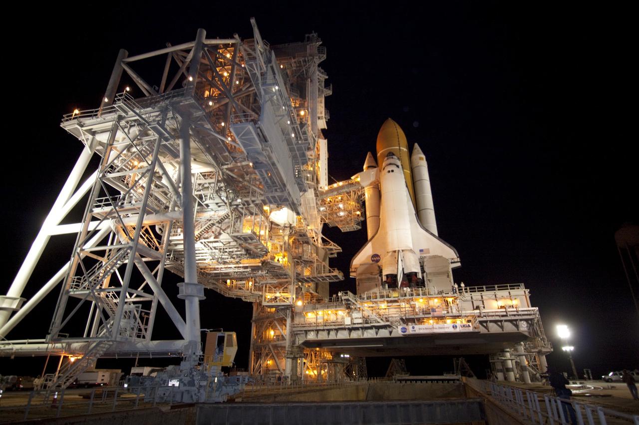 CAPE CANAVERAL, Fla. -- The rotating service structure (RSS), which provides weather protection and access to the shuttle, begins to move into place around space shuttle Discovery on Launch Pad 39A at NASA's Kennedy Space Center in Florida. This comes after Discovery, attached to its external fuel tank, twin solid rocket boosters and mobile launcher platform, rolled out to the pad from the Vehicle Assembly Building during the overnight hours. Rollout to the pad is a significant shuttle processing milestone for the upcoming STS-133 mission, and comes after a thorough check and modifications to the shuttle's external fuel tank. Targeted to liftoff Feb. 24, Discovery will take the Permanent Multipurpose Module (PMM) packed with supplies and critical spare parts, as well as Robonaut 2 (R2) to the International Space Station. For more information on STS-133, visit www.nasa.gov/mission_pages/shuttle/shuttlemissions/sts133/. Photo credit: NASA/Jack Pfaller