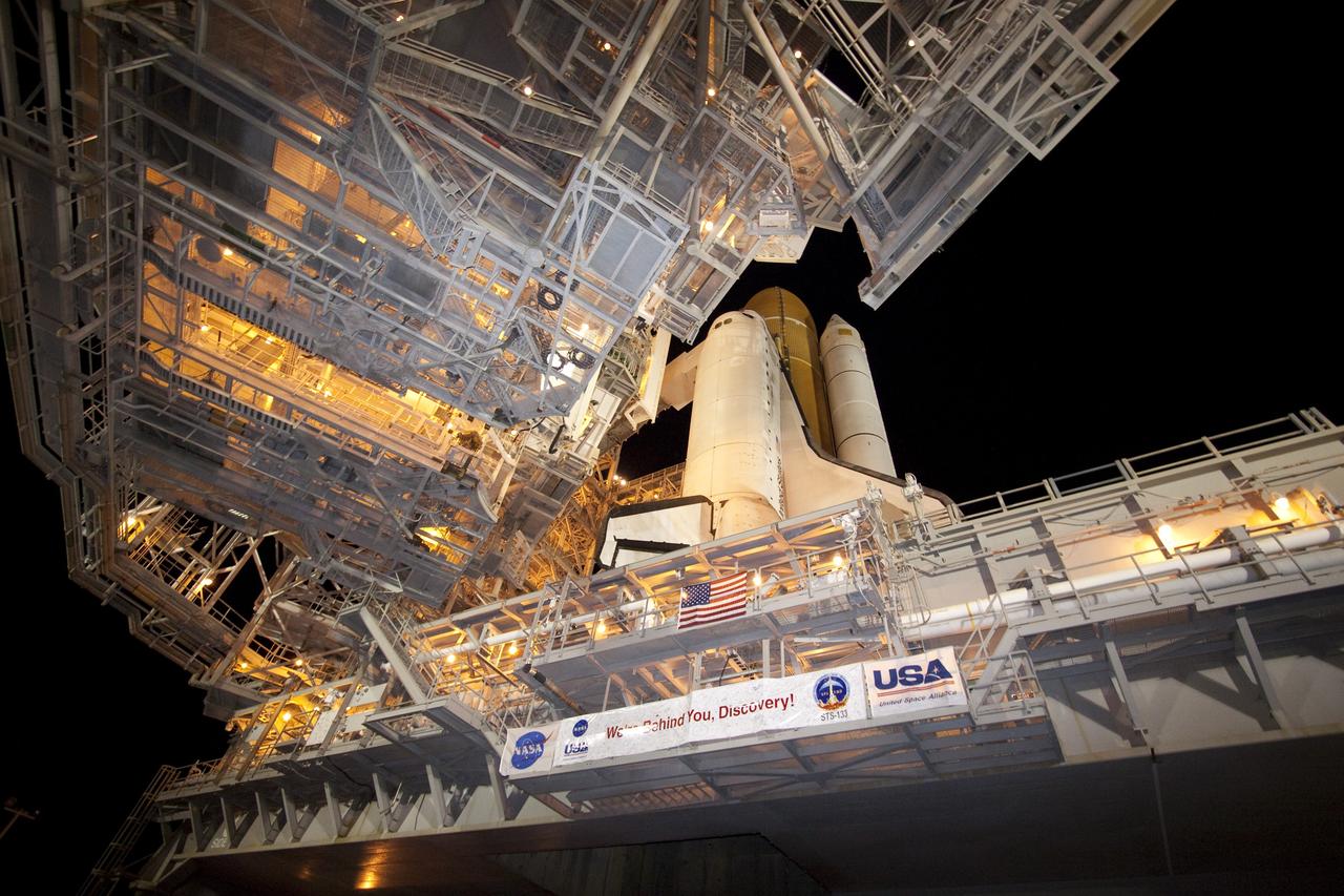 CAPE CANAVERAL, Fla. -- The rotating service structure (RSS), which provides weather protection and access to the shuttle, moves into place around space shuttle Discovery on Launch Pad 39A at NASA's Kennedy Space Center in Florida. This comes after Discovery, attached to its external fuel tank, twin solid rocket boosters and mobile launcher platform, rolled out to the pad from the Vehicle Assembly Building during the overnight hours. Rollout to the pad is a significant shuttle processing milestone for the upcoming STS-133 mission, and comes after a thorough check and modifications to the shuttle's external fuel tank. Targeted to liftoff Feb. 24, Discovery will take the Permanent Multipurpose Module (PMM) packed with supplies and critical spare parts, as well as Robonaut 2 (R2) to the International Space Station. For more information on STS-133, visit www.nasa.gov/mission_pages/shuttle/shuttlemissions/sts133/. Photo credit: NASA/Jack Pfaller