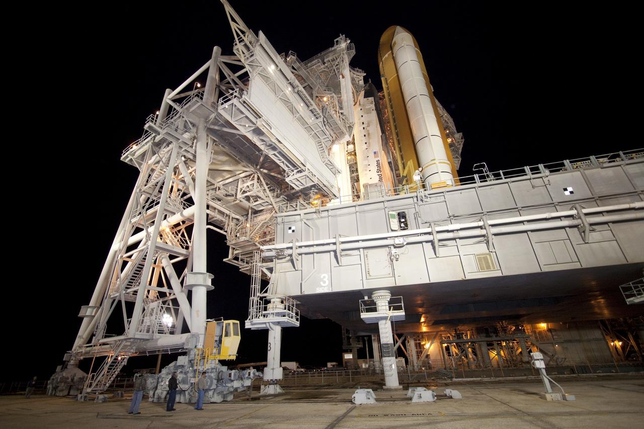 CAPE CANAVERAL, Fla. -- The rotating service structure (RSS), which provides weather protection and access to the shuttle, moves into place around space shuttle Discovery on Launch Pad 39A at NASA's Kennedy Space Center in Florida. This comes after Discovery, attached to its external fuel tank, twin solid rocket boosters and mobile launcher platform, rolled out to the pad from the Vehicle Assembly Building during the overnight hours. Rollout to the pad is a significant shuttle processing milestone for the upcoming STS-133 mission, and comes after a thorough check and modifications to the shuttle's external fuel tank. Targeted to liftoff Feb. 24, Discovery will take the Permanent Multipurpose Module (PMM) packed with supplies and critical spare parts, as well as Robonaut 2 (R2) to the International Space Station. For more information on STS-133, visit www.nasa.gov/mission_pages/shuttle/shuttlemissions/sts133/. Photo credit: NASA/Jack Pfaller