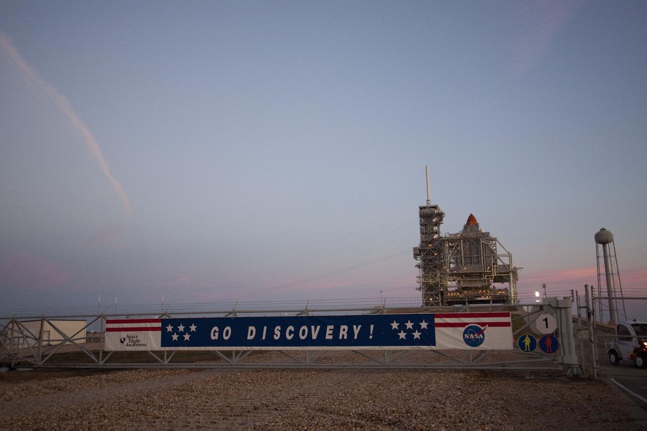CAPE CANAVERAL, Fla. -- As dawn breaks over the Atlantic Ocean near Launch Pad 39A at NASA's Kennedy Space Center in Florida, a banner proclaims the sentiments of the work force at Kennedy Space Center following the rollout of space shuttle Discovery to the pad. First motion on its 3.4-mile trip from the Vehicle Assembly Building was at 7:58 p.m. EST Jan. 31, and was secured or "hard down" on the pad a little before 3 a.m. Feb. 1. Discovery's next launch opportunity to the International Space Station on the STS-133 mission is targeted for Feb. 24. For more information on STS-133, visit www.nasa.gov/mission_pages/shuttle/shuttlemissions/sts133/. Photo credit: NASA/Jack Pfaller