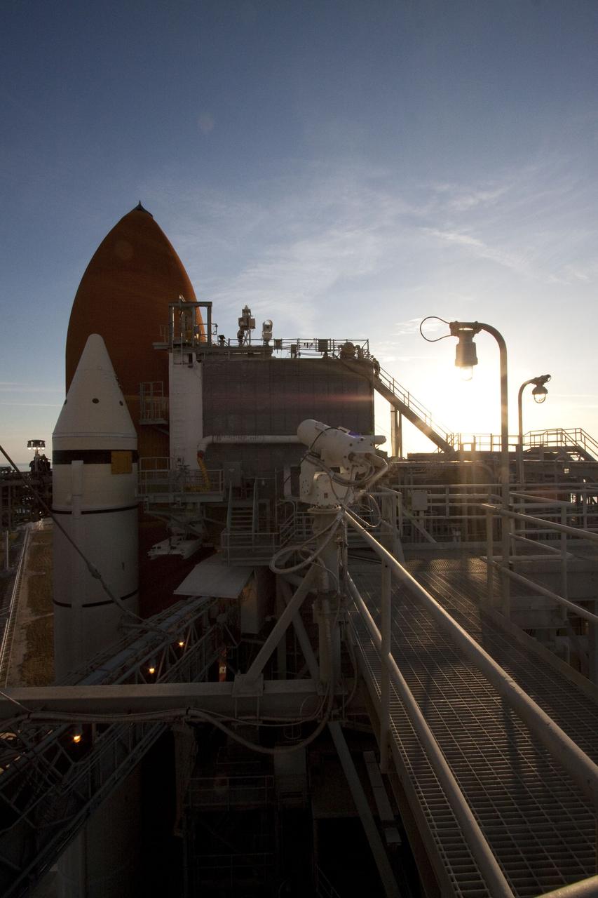 CAPE CANAVERAL, Fla. -- At NASA's Kennedy Space Center in Florida, this image of Launch Pad 39A from the 205-foot level reveals the rising sun over newly arrived space shuttle Discovery. The shuttle moved from the Vehicle Assembly Building with first motion at 7:58 p.m. EST Jan. 31, and was secured or "hard down" on the pad a little before 3 a.m. Feb. 1. Discovery's next launch opportunity to the International Space Station on the STS-133 mission is targeted for Feb. 24. For more information on STS-133, visit www.nasa.gov/mission_pages/shuttle/shuttlemissions/sts133/. Photo credit: NASA/Jack Pfaller