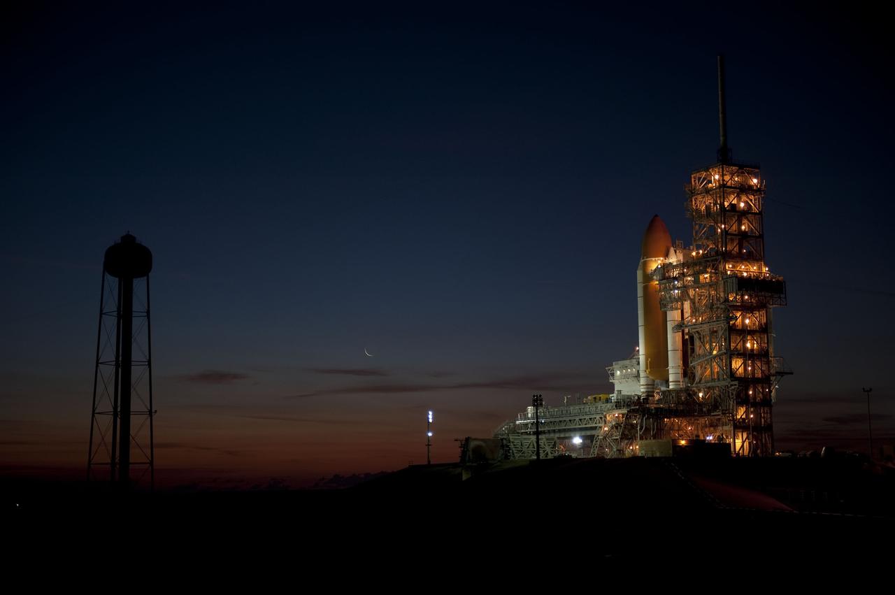 CAPE CANAVERAL, Fla. -- Dawn breaks over the Atlantic Ocean near Launch Pad 39A at NASA's Kennedy Space Center in Florida to reveal space shuttle Discovery newly arrived for its upcoming launch. First motion on its 3.4-mile trip from the Vehicle Assembly Building was at 7:58 p.m. EST Jan. 31, and was secured or "hard down" on the pad a little before 3 a.m. Feb. 1. Discovery's next launch opportunity to the International Space Station on the STS-133 mission is targeted for Feb. 24. For more information on STS-133, visit www.nasa.gov/mission_pages/shuttle/shuttlemissions/sts133/. Photo credit: NASA/Kim Shiflett