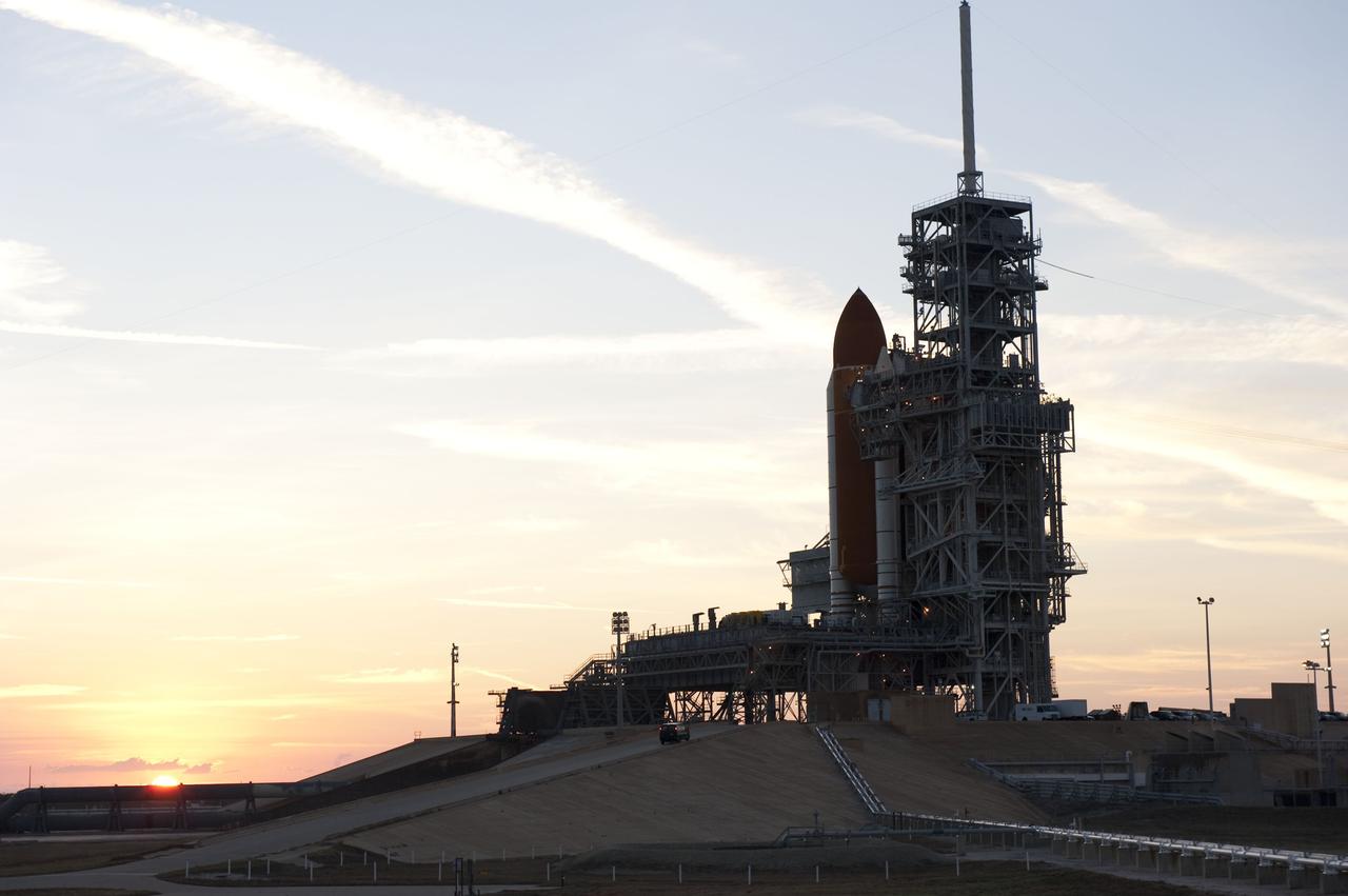 CAPE CANAVERAL, Fla. -- At NASA's Kennedy Space Center in Florida, the sun begins it rise in the East overlooking Launch Pad 39A and space shuttle Discovery, newly arrived for its upcoming launch. First motion on its 3.4-mile trip from the Vehicle Assembly Building was at 7:58 p.m. EST Jan. 31, and was secured or "hard down" on the pad a little before 3 a.m. Feb. 1. Discovery's next launch opportunity to the International Space Station on the STS-133 mission is targeted for Feb. 24. For more information on STS-133, visit www.nasa.gov/mission_pages/shuttle/shuttlemissions/sts133/. Photo credit: NASA/Kim Shiflett