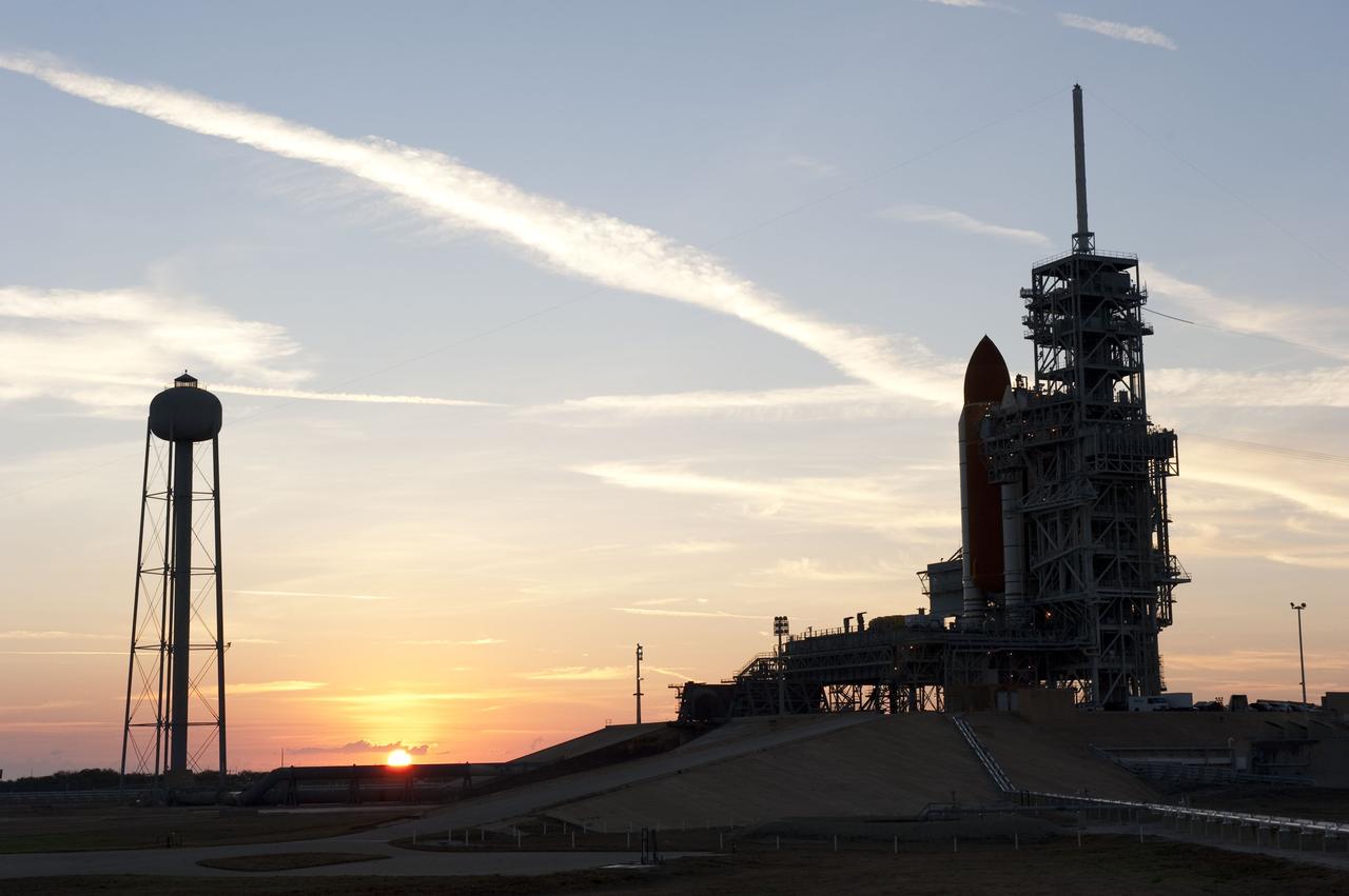 CAPE CANAVERAL, Fla. -- At NASA's Kennedy Space Center in Florida, the sun begins it rise in the East overlooking Launch Pad 39A and space shuttle Discovery, newly arrived for its upcoming launch. First motion on its 3.4-mile trip from the Vehicle Assembly Building was at 7:58 p.m. EST Jan. 31, and was secured or "hard down" on the pad a little before 3 a.m. Feb. 1. Discovery's next launch opportunity to the International Space Station on the STS-133 mission is targeted for Feb. 24. For more information on STS-133, visit www.nasa.gov/mission_pages/shuttle/shuttlemissions/sts133/. Photo credit: NASA/Kim Shiflett