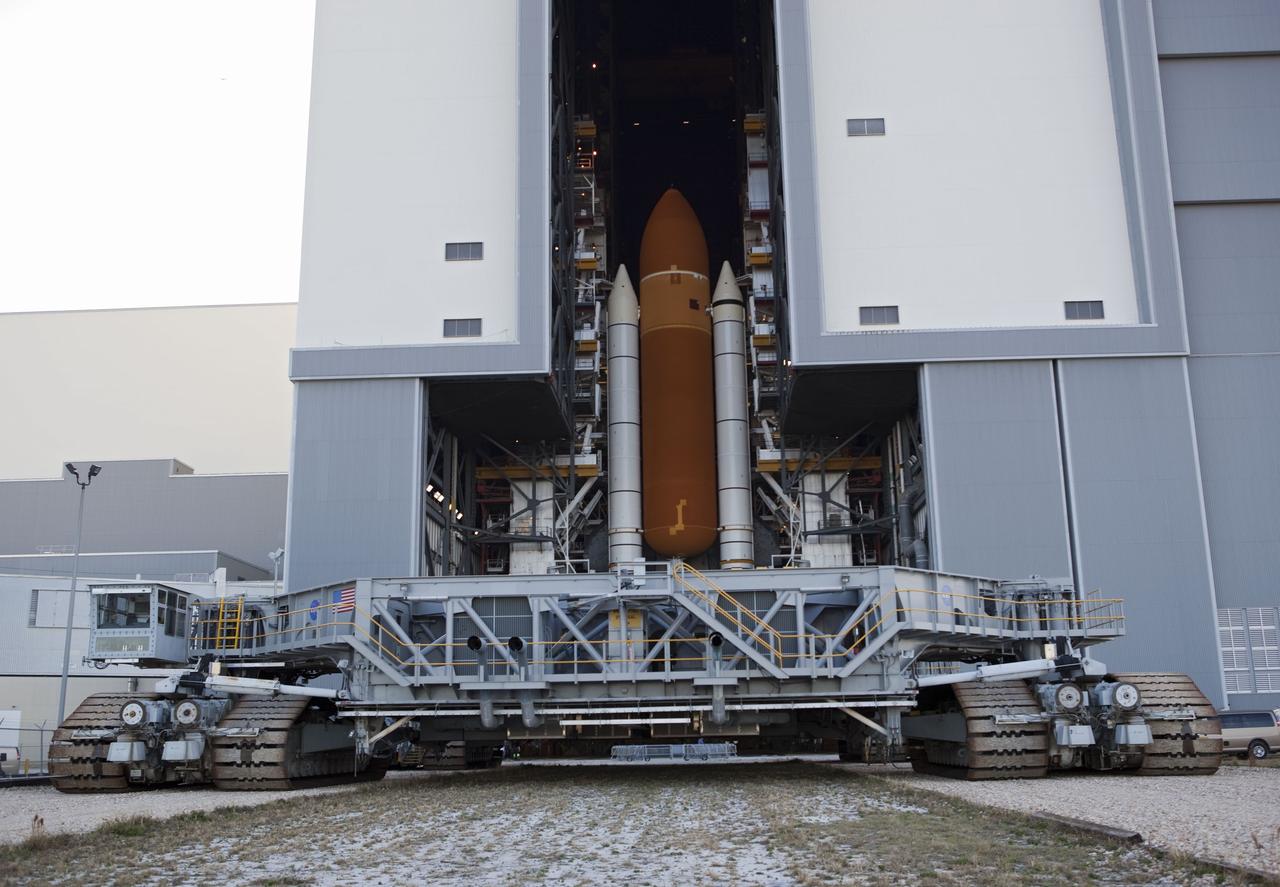 CAPE CANAVERAL, Fla. -- At NASA's Kennedy Space Center in Florida, space shuttle Discovery perched on a crawler-transporter in the doorway of the massive Vehicle Assembly Building, is ready for its 3.4-mile journey to Launch Pad 39A. It will take the shuttle, attached to its external fuel tank, twin solid rocket boosters and mobile launcher platform, about seven hours to complete the move. This is the second time Discovery has rolled out to the pad for the STS-133 mission, and comes after a thorough check and modifications to the shuttle's external tank. Targeted to liftoff Feb. 24, Discovery will take the Permanent Multipurpose Module (PMM) packed with supplies and critical spare parts, as well as Robonaut 2 (R2) to the International Space Station. For more information on STS-133, visit www.nasa.gov/mission_pages/shuttle/shuttlemissions/sts133/. Photo credit: NASA/Frank Michaux