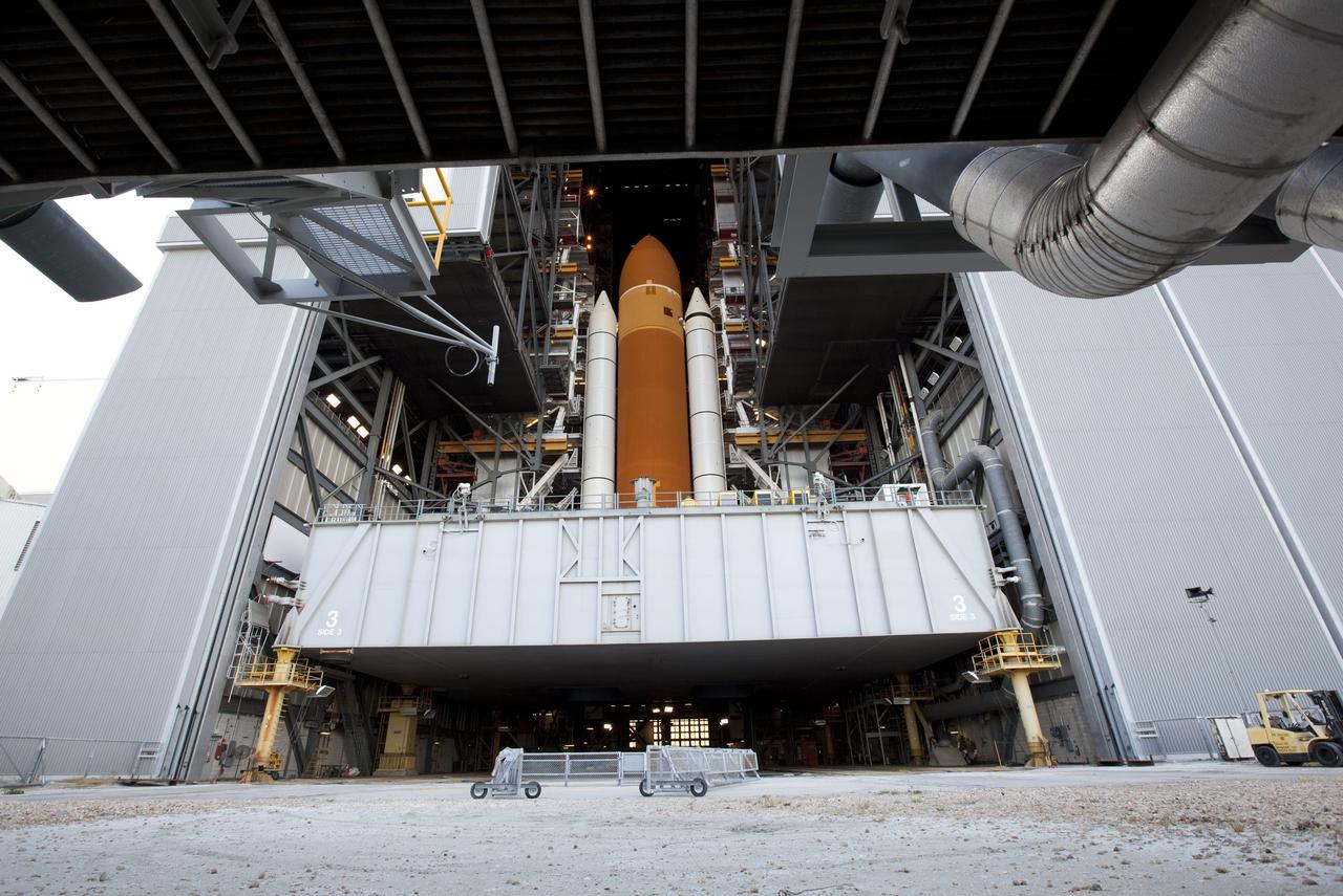 CAPE CANAVERAL, Fla. -- At NASA's Kennedy Space Center in Florida, space shuttle Discovery perched on a crawler-transporter in the doorway of the massive Vehicle Assembly Building, is ready for its 3.4-mile journey to Launch Pad 39A. It will take the shuttle, attached to its external fuel tank, twin solid rocket boosters and mobile launcher platform, about seven hours to complete the move. This is the second time Discovery has rolled out to the pad for the STS-133 mission, and comes after a thorough check and modifications to the shuttle's external tank. Targeted to liftoff Feb. 24, Discovery will take the Permanent Multipurpose Module (PMM) packed with supplies and critical spare parts, as well as Robonaut 2 (R2) to the International Space Station. For more information on STS-133, visit www.nasa.gov/mission_pages/shuttle/shuttlemissions/sts133/. Photo credit: NASA/Frank Michaux