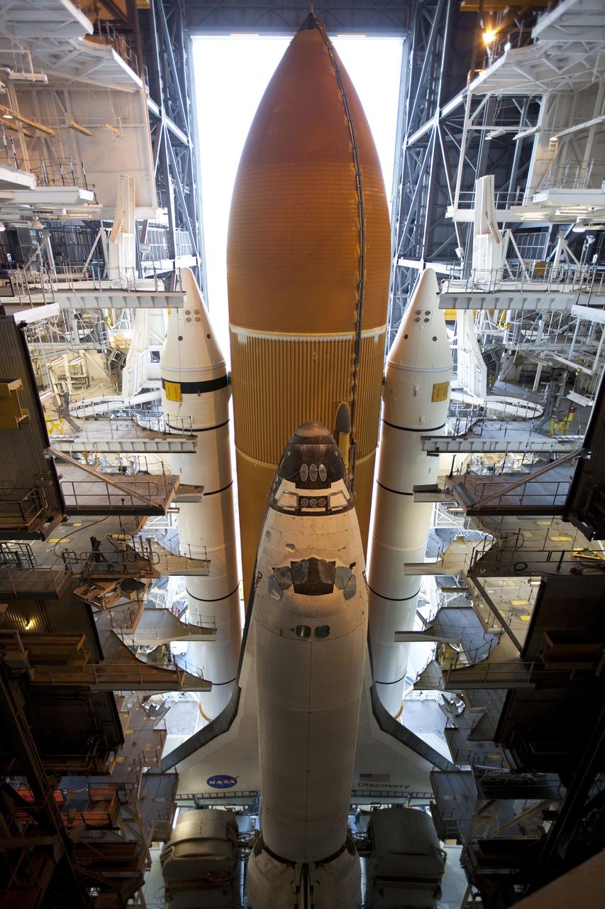 CAPE CANAVERAL, Fla. -- Viewed from inside the Vehicle Assembly Building at NASA's Kennedy Space Center in Florida, space shuttle Discovery, perched on a crawler-transporter in the doorway of the massive Vehicle Assembly Building, is ready for its 3.4-mile journey to Launch Pad 39A. It will take the shuttle, attached to its external fuel tank, twin solid rocket boosters and mobile launcher platform, about seven hours to complete the move. This is the second time Discovery has rolled out to the pad for the STS-133 mission, and comes after a thorough check and modifications to the shuttle's external tank. Targeted to liftoff Feb. 24, Discovery will take the Permanent Multipurpose Module (PMM) packed with supplies and critical spare parts, as well as Robonaut 2 (R2) to the International Space Station. For more information on STS-133, visit www.nasa.gov/mission_pages/shuttle/shuttlemissions/sts133/. Photo credit: NASA/Frank Michaux