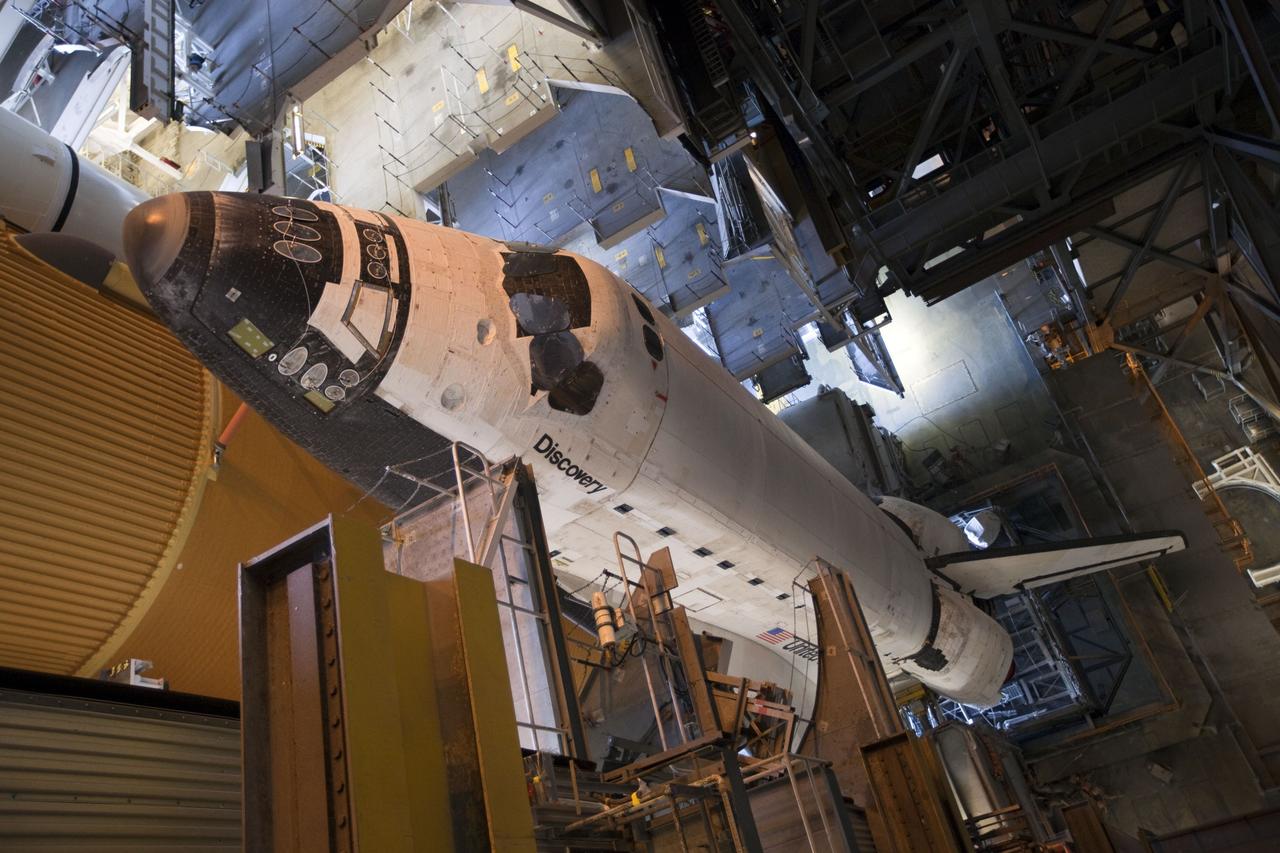 CAPE CANAVERAL, Fla. -- Viewed from inside the Vehicle Assembly Building at NASA's Kennedy Space Center in Florida, space shuttle Discovery, perched on a crawler-transporter in the doorway of the massive Vehicle Assembly Building, is ready for its 3.4-mile journey to Launch Pad 39A. It will take the shuttle, attached to its external fuel tank, twin solid rocket boosters and mobile launcher platform, about seven hours to complete the move. This is the second time Discovery has rolled out to the pad for the STS-133 mission, and comes after a thorough check and modifications to the shuttle's external tank. Targeted to liftoff Feb. 24, Discovery will take the Permanent Multipurpose Module (PMM) packed with supplies and critical spare parts, as well as Robonaut 2 (R2) to the International Space Station. For more information on STS-133, visit www.nasa.gov/mission_pages/shuttle/shuttlemissions/sts133/. Photo credit: NASA/Frank Michaux