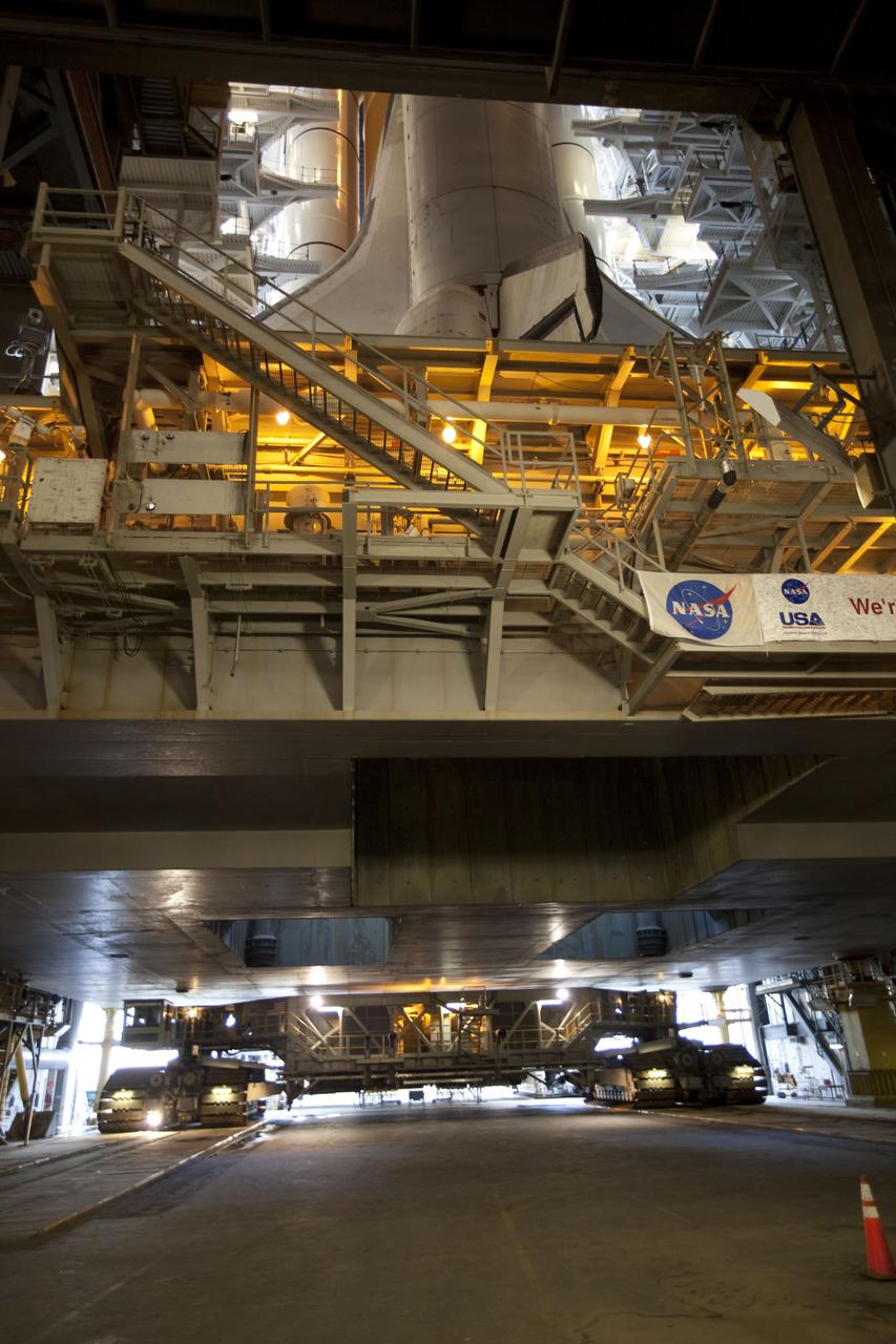 CAPE CANAVERAL, Fla. -- Viewed from inside the Vehicle Assembly Building at NASA's Kennedy Space Center in Florida, space shuttle Discovery, perched on a crawler-transporter in the doorway of the massive Vehicle Assembly Building, is ready for its 3.4-mile journey to Launch Pad 39A. It will take the shuttle, attached to its external fuel tank, twin solid rocket boosters and mobile launcher platform, about seven hours to complete the move. This is the second time Discovery has rolled out to the pad for the STS-133 mission, and comes after a thorough check and modifications to the shuttle's external tank. Targeted to liftoff Feb. 24, Discovery will take the Permanent Multipurpose Module (PMM) packed with supplies and critical spare parts, as well as Robonaut 2 (R2) to the International Space Station. For more information on STS-133, visit www.nasa.gov/mission_pages/shuttle/shuttlemissions/sts133/. Photo credit: NASA/Frank Michaux
