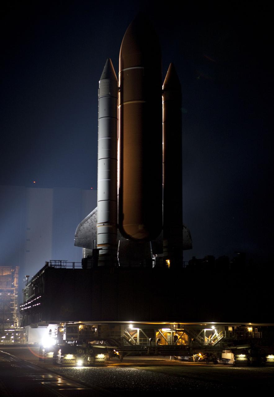 CAPE CANAVERAL, Fla. -- Xenon lights illuminate space shuttle Discovery as it makes its nighttime trek, known as "rollout," from the Vehicle Assembly Building to Launch Pad 39A at NASA's Kennedy Space Center in Florida. It will take the shuttle, attached to its external fuel tank, twin solid rocket boosters and mobile launcher platform, about seven hours to complete the move. This is the second time Discovery has rolled out to the pad for the STS-133 mission, and comes after a thorough check and modifications to the shuttle's external tank. Targeted to liftoff Feb. 24, Discovery will take the Permanent Multipurpose Module (PMM) packed with supplies and critical spare parts, as well as Robonaut 2 (R2) to the International Space Station. For more information on STS-133, visit www.nasa.gov/mission_pages/shuttle/shuttlemissions/sts133/. Photo credit: NASA/Frank Michaux