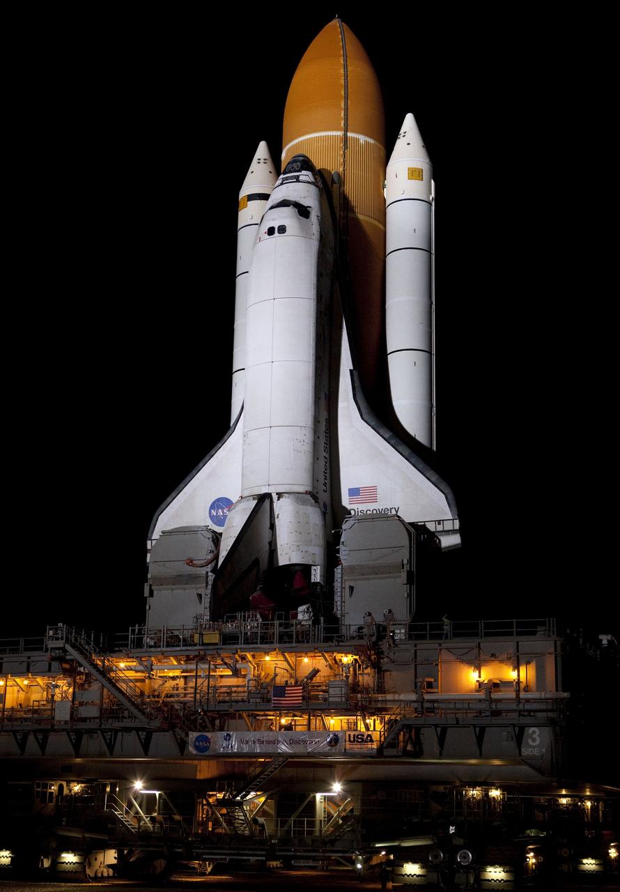 CAPE CANAVERAL, Fla. -- Xenon lights illuminate space shuttle Discovery as it makes its nighttime trek, known as "rollout," from the Vehicle Assembly Building to Launch Pad 39A at NASA's Kennedy Space Center in Florida. It will take the shuttle, attached to its external fuel tank, twin solid rocket boosters and mobile launcher platform, about seven hours to complete the move. This is the second time Discovery has rolled out to the pad for the STS-133 mission, and comes after a thorough check and modifications to the shuttle's external tank. Targeted to liftoff Feb. 24, Discovery will take the Permanent Multipurpose Module (PMM) packed with supplies and critical spare parts, as well as Robonaut 2 (R2) to the International Space Station. For more information on STS-133, visit www.nasa.gov/mission_pages/shuttle/shuttlemissions/sts133/. Photo credit: NASA/Frank Michaux