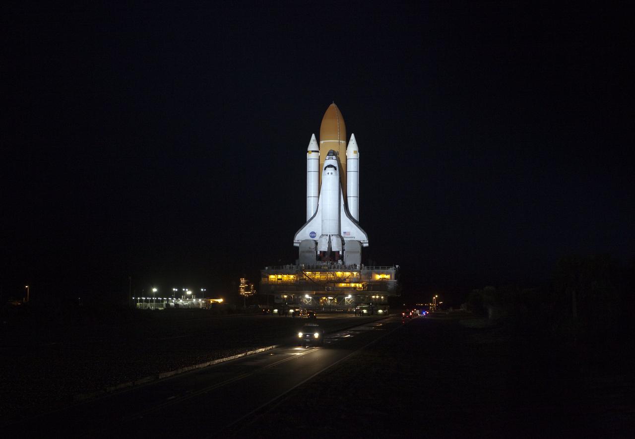 CAPE CANAVERAL, Fla. -- Xenon lights illuminate space shuttle Discovery as it makes its nighttime trek, known as "rollout," from the Vehicle Assembly Building to Launch Pad 39A at NASA's Kennedy Space Center in Florida. It will take the shuttle, attached to its external fuel tank, twin solid rocket boosters and mobile launcher platform, about seven hours to complete the move. This is the second time Discovery has rolled out to the pad for the STS-133 mission, and comes after a thorough check and modifications to the shuttle's external tank. Targeted to liftoff Feb. 24, Discovery will take the Permanent Multipurpose Module (PMM) packed with supplies and critical spare parts, as well as Robonaut 2 (R2) to the International Space Station. For more information on STS-133, visit www.nasa.gov/mission_pages/shuttle/shuttlemissions/sts133/. Photo credit: NASA/Frank Michaux
