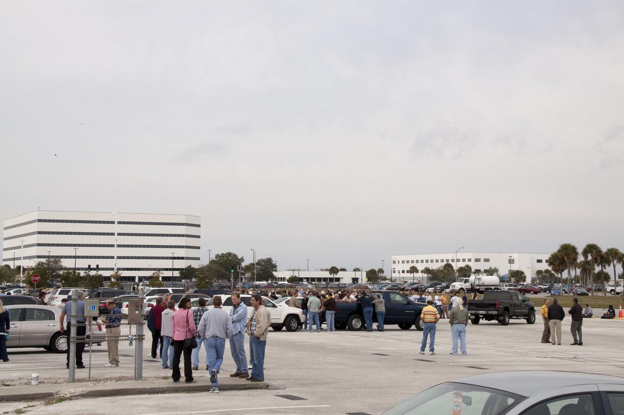 CAPE CANAVERAL, Fla. -- Workers wait to return to their buildings at NASA's Kennedy Space Center in Florida, after a backhoe inadvertently struck a natural gas line at around 8:40 a.m. EST in the area north of the Multi Function Facility (MFF). As a precaution, personnel were evacuated from Orbiter Processing Facilities 1 and 2, the MFF, Processing Control Center and Operations Support Building (OSB) I. All traffic was blocked on the Saturn Causeway near the facilities. There were no injuries or damage to any facilities and personnel were allowed back into their buildings before mid-day and the roadway open to traffic. Photo credit: NASA/Jack Pfaller