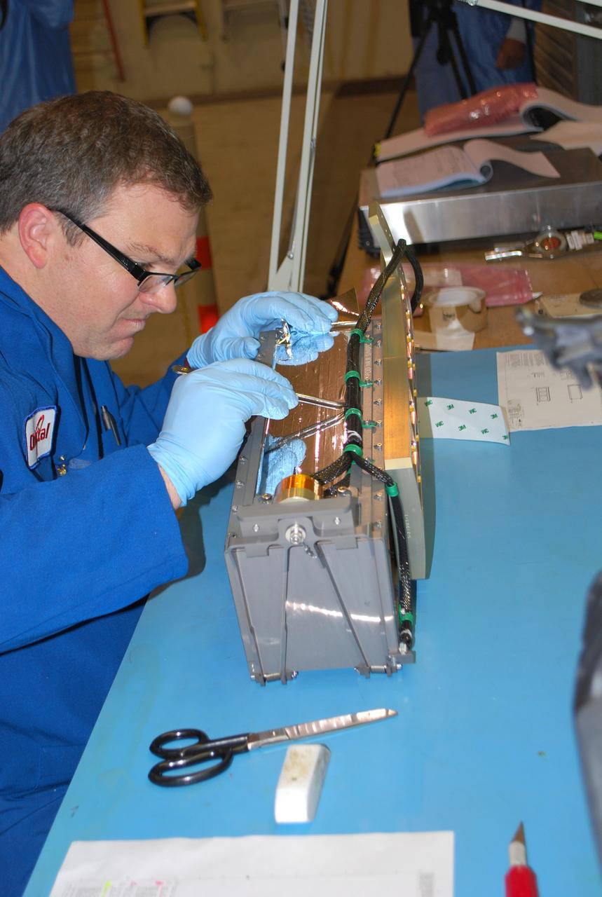 VANDENBERG AIR FORCE BASE, Calif. -- At Vandenberg Air Force Base in California, a technician installs a bracket on a Poly Picosatellite Orbital Deployer, or P-POD, container. The bracket is a connection interface between the P-POD and the Taurus rocket. The P-POD will hold three CubeSats or tiny satellites, designed and created by university and college students that will be carried on the Taurus rocket along with the Glory spacecraft.            The Orbital Sciences Corp. Taurus XL rocket will carry NASA's Glory spacecraft into low Earth orbit. Once Glory reaches orbit, it will collect data on the properties of aerosols and black carbon. It also will help scientists understand how the sun's irradiance affects Earth's climate. Launch is scheduled for 5:09 a.m. EST Feb. 23. For information, visit www.nasa.gov/glory. Photo credit: NASA/Randy Beaudoin, VAFB