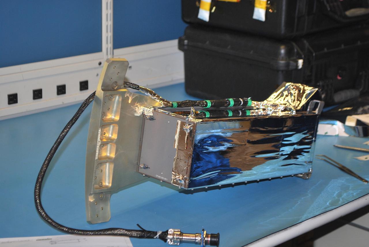 VANDENBERG AIR FORCE BASE, Calif. -- At Vandenberg Air Force Base in California, a Poly Picosatellite Orbital Deployer, or P-POD, container is imaged here with the bracket interface installed. The bracket is a connection interface between the P-POD and the Taurus rocket. The P-POD will hold three CubeSats or tiny satellites, designed and created by university and college students that will be carried on the Taurus rocket along with the Glory spacecraft.        The Orbital Sciences Corp. Taurus XL rocket will carry NASA's Glory spacecraft into low Earth orbit. Once Glory reaches orbit, it will collect data on the properties of aerosols and black carbon. It also will help scientists understand how the sun's irradiance affects Earth's climate. Launch is scheduled for 5:09 a.m. EST Feb. 23. For information, visit www.nasa.gov/glory. Photo credit: NASA/Randy Beaudoin, VAFB