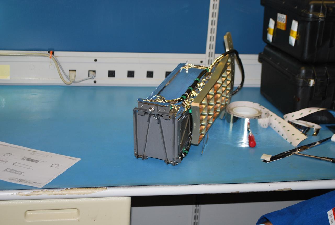 VANDENBERG AIR FORCE BASE, Calif. -- At Vandenberg Air Force Base in California, a Poly Picosatellite Orbital Deployer, or P-POD, container is imaged here with the bracket interface installed. The bracket is a connection interface between the P-POD and the Taurus rocket. The P-POD will hold three CubeSats or tiny satellites, designed and created by university and college students that will be carried on the Taurus rocket along with the Glory spacecraft.        The Orbital Sciences Corp. Taurus XL rocket will carry NASA's Glory spacecraft into low Earth orbit. Once Glory reaches orbit, it will collect data on the properties of aerosols and black carbon. It also will help scientists understand how the sun's irradiance affects Earth's climate. Launch is scheduled for 5:09 a.m. EST Feb. 23. For information, visit www.nasa.gov/glory. Photo credit: NASA/Randy Beaudoin,VAFB