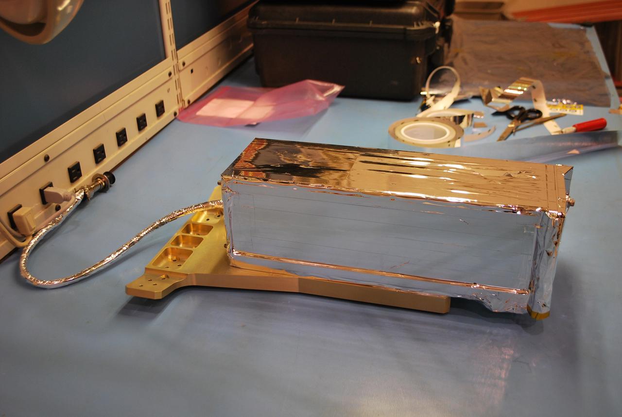 VANDENBERG AIR FORCE BASE, Calif. -- At Vandenberg Air Force Base in California, a Poly Picosatellite Orbital Deployer, or P-POD, container is imaged here after a sheet of thermal insulation has been applied and the bracket interface installed. The bracket will serve as a connection interface between the P-POD and the Taurus rocket. The P-POD will hold three CubeSats or tiny satellites, designed and created by university and college students that will be carried on the Taurus rocket along with the Glory spacecraft.    The Orbital Sciences Corp. Taurus XL rocket will carry NASA's Glory spacecraft into low Earth orbit. Once Glory reaches orbit, it will collect data on the properties of aerosols and black carbon. It also will help scientists understand how the sun's irradiance affects Earth's climate. Launch is scheduled for 5:09 a.m. EST Feb. 23. For information, visit www.nasa.gov/glory. Photo credit: NASA/Randy Beaudoin, VAFB