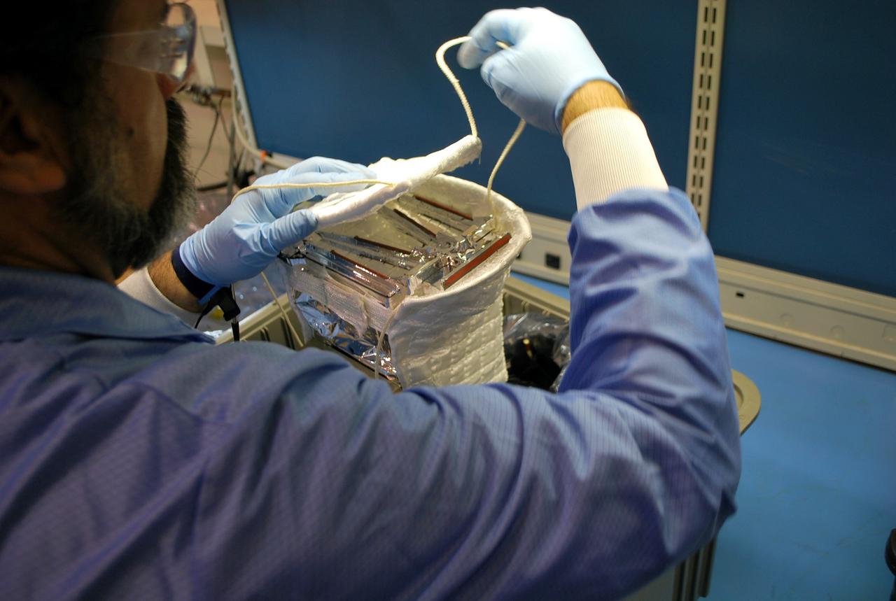 VANDENBERG AIR FORCE BASE, Calif. -- At Vandenberg Air Force Base in California, a technician wraps the Poly Picosatellite Orbital Deployer, or P-POD, container in a protective insulation blanket. The P-POD will hold three CubeSats or tiny satellites, designed and created by university and college students that will be carried on the Taurus rocket along with the Glory spacecraft. The Orbital Sciences Corp. Taurus XL rocket will carry NASA's Glory spacecraft into low Earth orbit. Once Glory reaches orbit, it will collect data on the properties of aerosols and black carbon. It also will help scientists understand how the sun's irradiance affects Earth's climate. Launch is scheduled for 5:09 a.m. EST Feb. 23. For information, visit www.nasa.gov/glory. Photo credit: NASA/Randy Beaudoin, VAFB