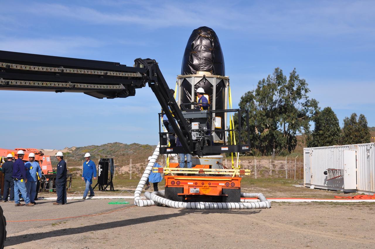 VANDENBERG AIR FORCE BASE, Calif. -- At Space Launch Complex 576-E at Vandenberg Air Force Base in California, NASA's Glory spacecraft, encapsulated in its protective fairing, is being prepared to be lifted off of a transport. It will then be joined with the Taurus XL rocket's third stage, already delivered to a temporary processing tent near the pad.The Orbital Sciences Corp. Taurus XL rocket will carry Glory into low Earth orbit. Once Glory reaches orbit, it will collect data on the properties of aerosols and black carbon. It also will help scientists understand how the sun's irradiance affects Earth's climate. Launch is scheduled for 5:09 a.m. EST Feb. 23. For information, visit www.nasa.gov/glory. Photo credit: NASA/Randy Beaudoin, VAFB