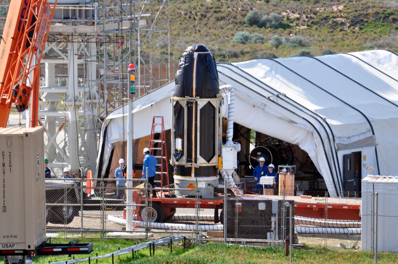VANDENBERG AIR FORCE BASE, Calif. -- At Space Launch Complex 576-E at Vandenberg Air Force Base in California, workers prepare NASA's Glory spacecraft, encapsulated in its protective fairing, to be lifted off of a transport. It will then be joined with the Taurus XL rocket's third stage, already delivered to a temporary processing tent near the pad.            The Orbital Sciences Corp. Taurus XL rocket will carry Glory into low Earth orbit. Once Glory reaches orbit, it will collect data on the properties of aerosols and black carbon. It also will help scientists understand how the sun's irradiance affects Earth's climate. Launch is scheduled for 5:09 a.m. EST Feb. 23. For information, visit www.nasa.gov/glory. Photo credit: NASA/Randy Beaudoin, VAFB