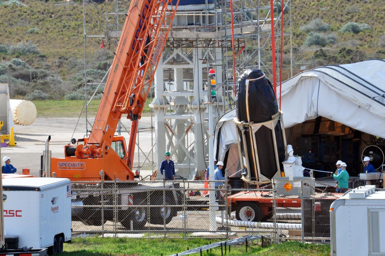 VANDENBERG AIR FORCE BASE, Calif. -- At Space Launch Complex 576-E at Vandenberg Air Force Base in California, a crane lifts NASA's Glory spacecraft, encapsulated in its protective fairing, off of a transport. It will then be joined with the Taurus XL rocket's third stage, already delivered to a temporary processing tent near the pad.            The Orbital Sciences Corp. Taurus XL rocket will carry Glory into low Earth orbit. Once Glory reaches orbit, it will collect data on the properties of aerosols and black carbon. It also will help scientists understand how the sun's irradiance affects Earth's climate. Launch is scheduled for 5:09 a.m. EST Feb. 23. For information, visit www.nasa.gov/glory. Photo credit: NASA/Randy Beaudoin, VAFB