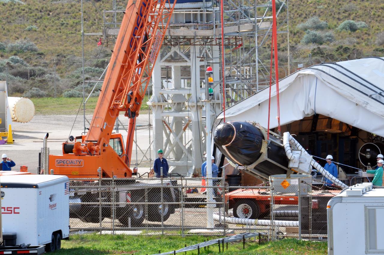VANDENBERG AIR FORCE BASE, Calif. -- At Space Launch Complex 576-E at Vandenberg Air Force Base in California, a crane maneuvers NASA's Glory spacecraft, encapsulated in its protective fairing, onto a stationary rail. There it will then be joined with the Taurus XL rocket's third stage, already delivered to a temporary processing tent near the pad.            The Orbital Sciences Corp. Taurus XL rocket will carry Glory into low Earth orbit. Once Glory reaches orbit, it will collect data on the properties of aerosols and black carbon. It also will help scientists understand how the sun's irradiance affects Earth's climate. Launch is scheduled for 5:09 a.m. EST Feb. 23. For information, visit www.nasa.gov/glory. Photo credit: NASA/Randy Beaudoin, VAFB