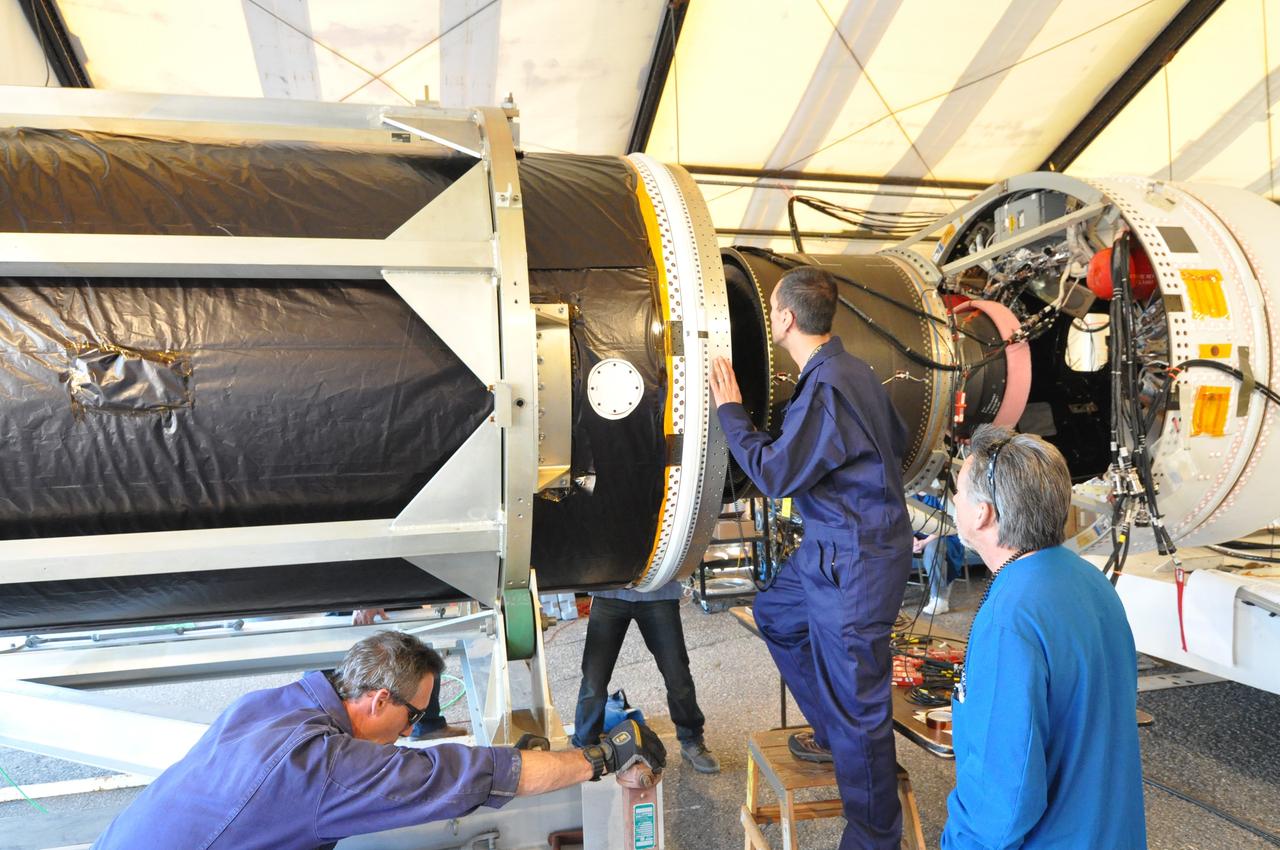 VANDENBERG AIR FORCE BASE, Calif. -- At Vandenberg Air Force Base in California, technicians join NASA's Glory spacecraft with the Taurus XL rocket's third stage, housed inside a temporary processing tent near the pad at Space Launch Complex 576-E.        The Orbital Sciences Corp. Taurus XL rocket will carry Glory into low Earth orbit. Once Glory reaches orbit, it will collect data on the properties of aerosols and black carbon. It also will help scientists understand how the sun's irradiance affects Earth's climate. Launch is scheduled for 5:09 a.m. EST Feb. 23. For information, visit www.nasa.gov/glory. Photo credit: NASA/Randy Beaudoin, VAFB