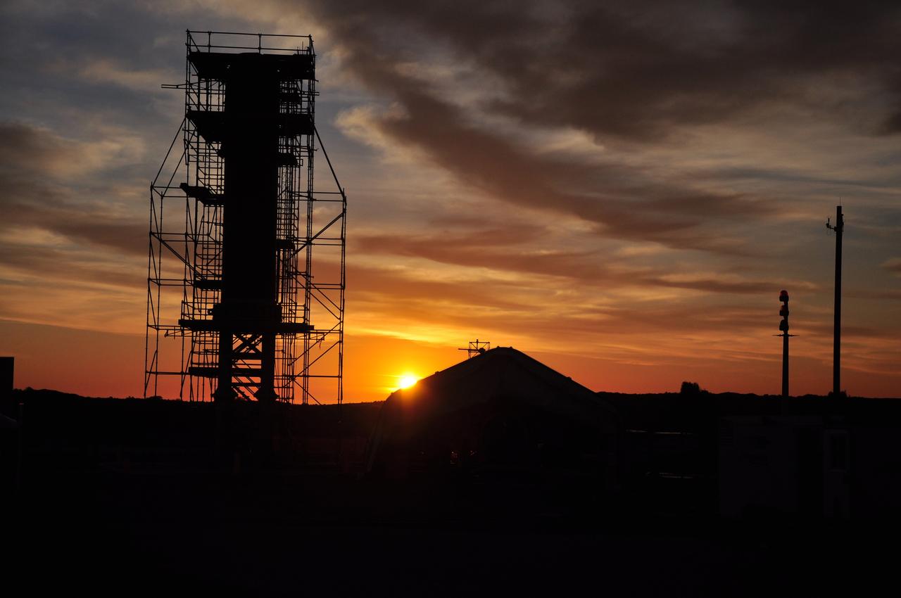VANDENBERG AIR FORCE BASE, Calif. -- At Vandenberg Air Force Base in California,  the sun sets over Space Launch Complex 576-E where technicians continue the process of joining  NASA's Glory spacecraft with the Taurus XL rocket's third stage, housed inside a temporary processing tent near the pad.      The Orbital Sciences Corp. Taurus XL rocket will carry Glory into low Earth orbit. Once Glory reaches orbit, it will collect data on the properties of aerosols and black carbon. It also will help scientists understand how the sun's irradiance affects Earth's climate. Launch is scheduled for 5:09 a.m. EST Feb. 23. For information, visit www.nasa.gov/glory. Photo credit: NASA/Randy Beaudoin, VAFB