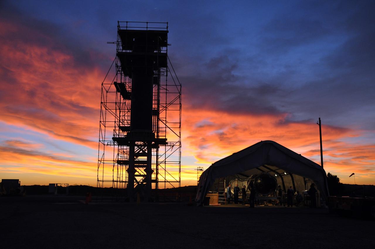 VANDENBERG AIR FORCE BASE, Calif. -- At Vandenberg Air Force Base in California,  the sun sets over Space Launch Complex 576-E where technicians continue the process of joining  NASA's Glory spacecraft with the Taurus XL rocket's third stage, housed inside a temporary processing tent near the pad.      The Orbital Sciences Corp. Taurus XL rocket will carry Glory into low Earth orbit. Once Glory reaches orbit, it will collect data on the properties of aerosols and black carbon. It also will help scientists understand how the sun's irradiance affects Earth's climate. Launch is scheduled for 5:09 a.m. EST Feb. 23. For information, visit www.nasa.gov/glory. Photo credit: NASA/Randy Beaudoin, VAFB