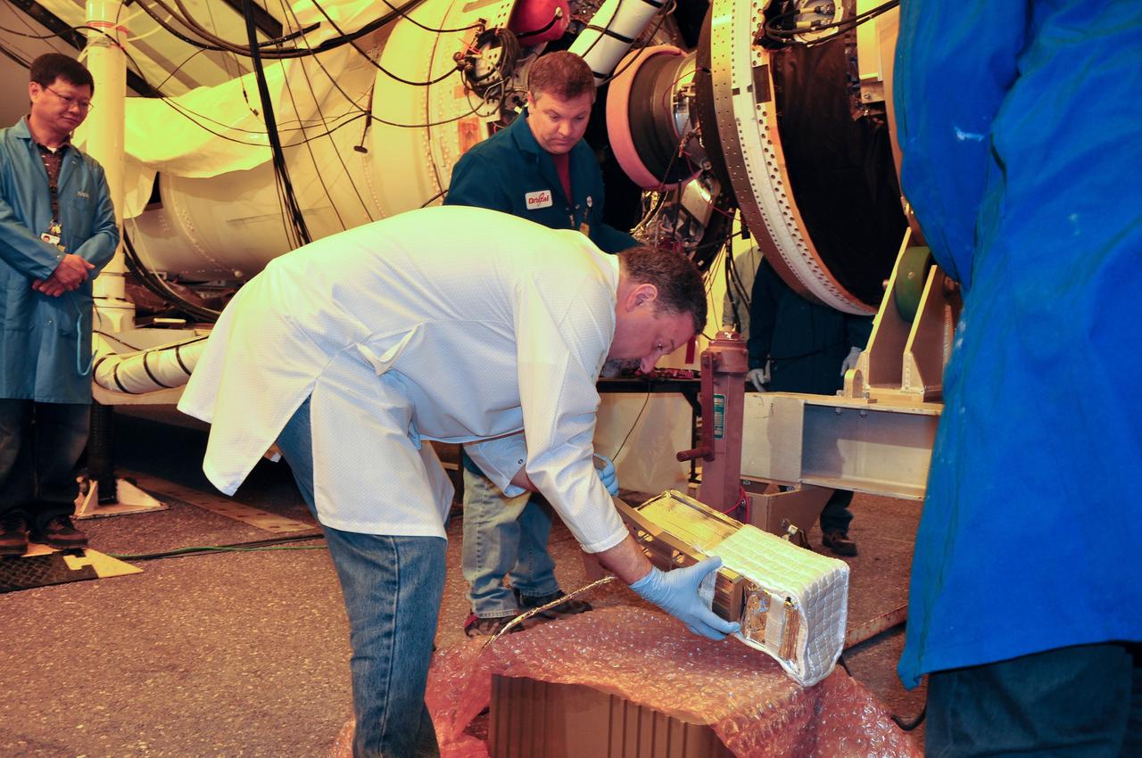 VANDENBERG AIR FORCE BASE, Calif. -- At Space Launch Complex 576-E at Vandenberg Air Force Base in California, a technician lifts the Poly Picosatellite Orbital Deployer, or P-POD, assembly by the Anodized gold aluminum bracket interface. The bracket is the connection point between the P-POD and the aft end of the Taurus rocket's third stage. The P-POD holds three CubeSats or tiny satellites, designed and created by university and college students that will be carried on the Taurus rocket along with the Glory spacecraft.      The Orbital Sciences Corp. Taurus XL rocket will carry Glory into low Earth orbit. Once Glory reaches orbit, it will collect data on the properties of aerosols and black carbon. It also will help scientists understand how the sun's irradiance affects Earth's climate. Launch is scheduled for 5:09 a.m. EST Feb. 23. For information, visit www.nasa.gov/glory. Photo credit: NASA/Randy Beaudoin, VAFB