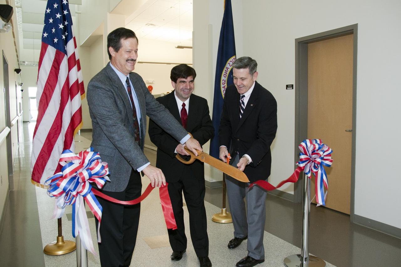 CAPE CANAVERAL, Fla. -- A traditional ribbon-cutting ceremony takes place inside the new 18,500-square-foot Electrical Maintenance Facility (EMF) at NASA's Kennedy Space Center in Florida. From left are Kennedy Director of Operations Mike Benik, NASA Construction of Facility Project Manager Nick Rivieccio and Kennedy Center Director Bob Cabana. Located in Kennedy's Launch Complex 39 area, the EMF will provide new and renovated space for maintenance shops, offices, and equipment and material storage in support of the electrical maintenance functions for the center. The facility is projected to receive Gold certification under the U.S. Green Building Council’s Leadership in Energy and Environmental Design (LEED) rating system. Photo credit: NASA/ Troy Cryder