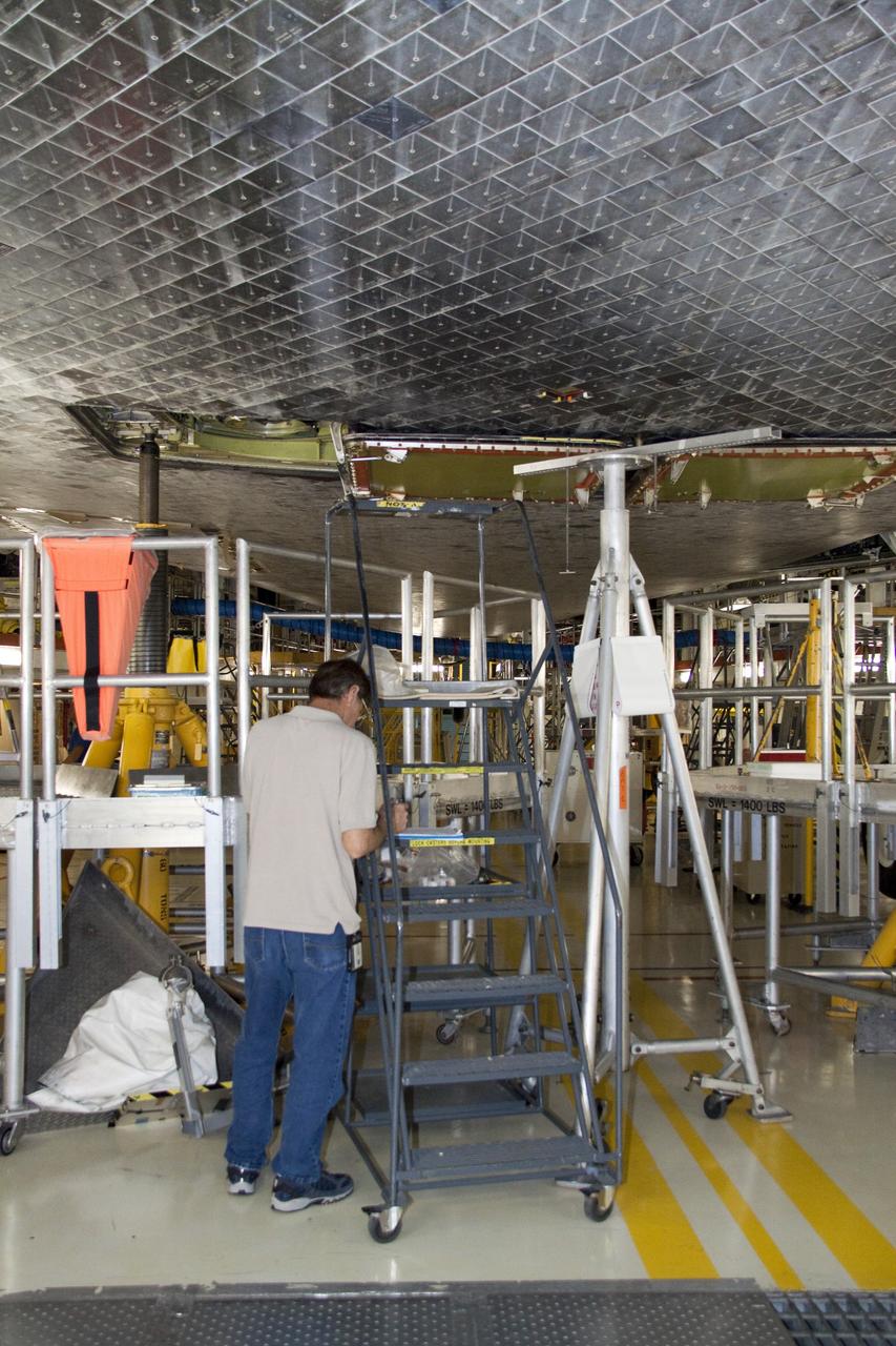 CAPE CANAVERAL, Fla. -- In Orbiter Processing Facility-1 at NASA's Kennedy Space Center in Florida, a thermal protection system technician is ready to work on replacing some of space shuttle Atlantis' heat shield tiles. The tiles are part of the Orbiter Thermal Protection System, thermal shields to protect against temperatures as high as 3,000 degrees Fahrenheit, which are produced during descent for landing.            Atlantis is being prepared for the STS-135 mission, which will deliver the Raffaello multi-purpose logistics module packed with supplies, logistics and spare parts to the International Space Station. STS-135 is targeted to launch June 28, and will be the last spaceflight for the Space Shuttle Program. Photo credit: NASA/Jack Pfaller