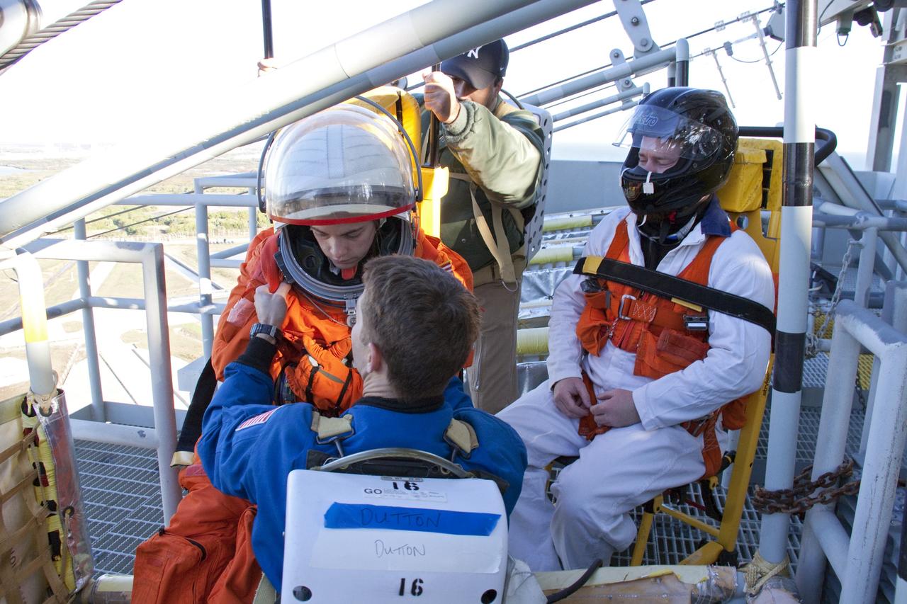 CAPE CANAVERAL, Fla. -- At NASA's Kennedy Space Center in Florida, members of an emergency escape training team perform a simulated evacuation exercise at Launch Pad 39A.           For several days, volunteers portraying astronauts, take part in training exercises which allow teams to practice emergency response procedures, including helicopter evacuation to local hospitals. Training normally involves NASA fire rescue personnel, personnel from the Air Force's 920th Rescue Wing, and medical trauma teams from central Florida hospitals, and is required every 18 months to certify Fire Rescue and Closeout Crew personnel. Photo credit: NASA/Troy Cryder