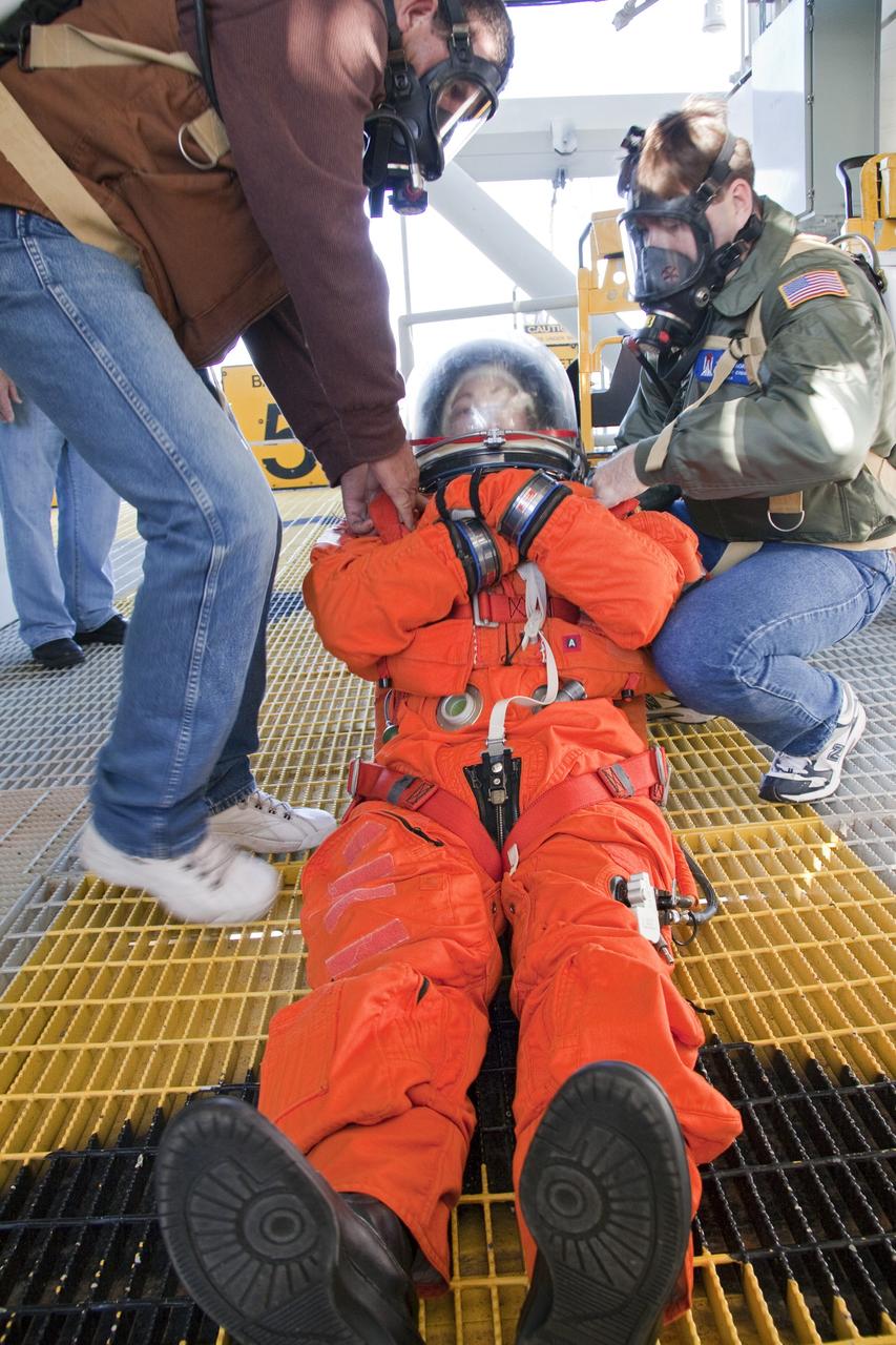 CAPE CANAVERAL, Fla. -- At NASA's Kennedy Space Center in Florida, members of an emergency escape training team perform a simulated evacuation exercise at Launch Pad 39A.           For several days, volunteers portraying astronauts, take part in training exercises which allow teams to practice emergency response procedures, including helicopter evacuation to local hospitals. Training normally involves NASA fire rescue personnel, personnel from the Air Force's 920th Rescue Wing, and medical trauma teams from central Florida hospitals, and is required every 18 months to certify Fire Rescue and Closeout Crew personnel. Photo credit: NASA/Troy Cryder