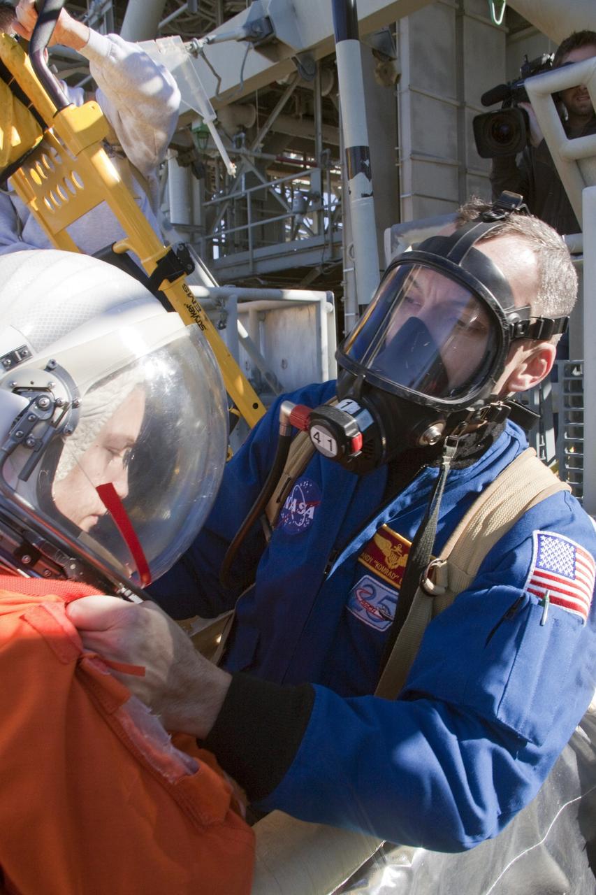 CAPE CANAVERAL, Fla. -- At NASA's Kennedy Space Center in Florida, members of an emergency escape training team perform a simulated evacuation exercise at Launch Pad 39A.           For several days, volunteers portraying astronauts, take part in training exercises which allow teams to practice emergency response procedures, including helicopter evacuation to local hospitals. Training normally involves NASA fire rescue personnel, personnel from the Air Force's 920th Rescue Wing, and medical trauma teams from central Florida hospitals, and is required every 18 months to certify Fire Rescue and Closeout Crew personnel. Photo credit: NASA/Troy Cryder