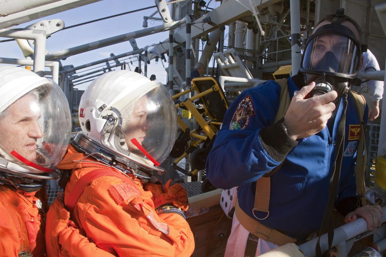 CAPE CANAVERAL, Fla. -- At NASA's Kennedy Space Center in Florida, members of an emergency escape training team perform a simulated evacuation exercise at Launch Pad 39A.           For several days, volunteers portraying astronauts, take part in training exercises which allow teams to practice emergency response procedures, including helicopter evacuation to local hospitals. Training normally involves NASA fire rescue personnel, personnel from the Air Force's 920th Rescue Wing, and medical trauma teams from central Florida hospitals, and is required every 18 months to certify Fire Rescue and Closeout Crew personnel. Photo credit: NASA/Troy Cryder