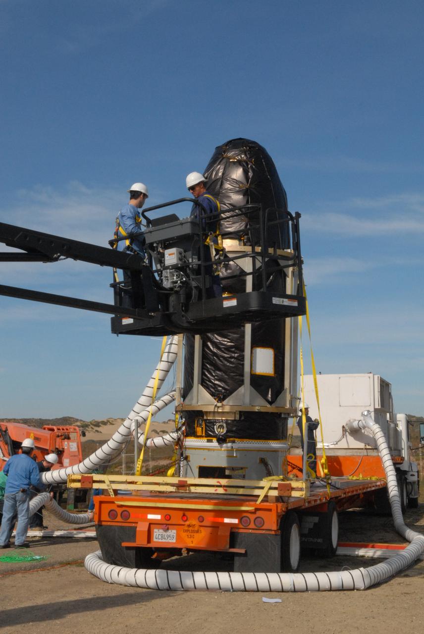 VANDENBERG AIR FORCE BASE, Calif. -- At Space Launch Complex 576-E at Vandenberg Air Force Base in California, workers prepare NASA's Glory spacecraft, encapsulated in its protective fairing, to be lifted off of a transport. It will then be joined with the Taurus XL rocket's third stage, already delivered to a temporary processing tent near the pad. The Orbital Sciences Corp. Taurus XL rocket will carry Glory into low Earth orbit.          Once Glory reaches orbit, it will collect data on the properties of aerosols and black carbon. It also will help scientists understand how the sun's irradiance affects Earth's climate. Launch is scheduled for 5:09 a.m. EST Feb. 23. For information, visit www.nasa.gov/glory. Photo credit: NASA/Jerry E. Clemens Jr., VAFB