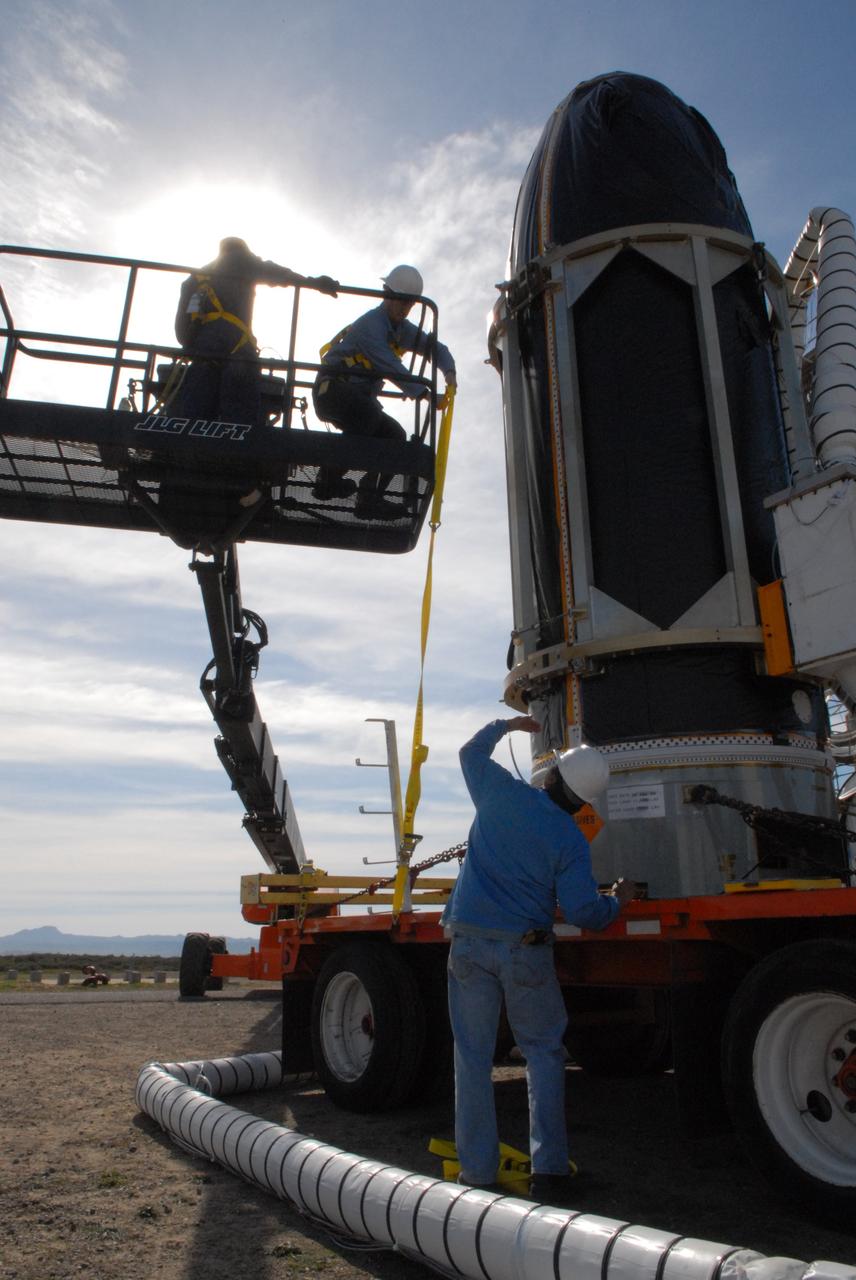 VANDENBERG AIR FORCE BASE, Calif. -- At Space Launch Complex 576-E at Vandenberg Air Force Base in California, workers prepare NASA's Glory spacecraft, encapsulated in its protective fairing, to be lifted off of a transport. It will then be joined with the Taurus XL rocket's third stage, already delivered to a temporary processing tent near the pad. The Orbital Sciences Corp. Taurus XL rocket will carry Glory into low Earth orbit.          Once Glory reaches orbit, it will collect data on the properties of aerosols and black carbon. It also will help scientists understand how the sun's irradiance affects Earth's climate. Launch is scheduled for 5:09 a.m. EST Feb. 23. For information, visit www.nasa.gov/glory. Photo credit: NASA/Jerry E. Clemens Jr., VAFB